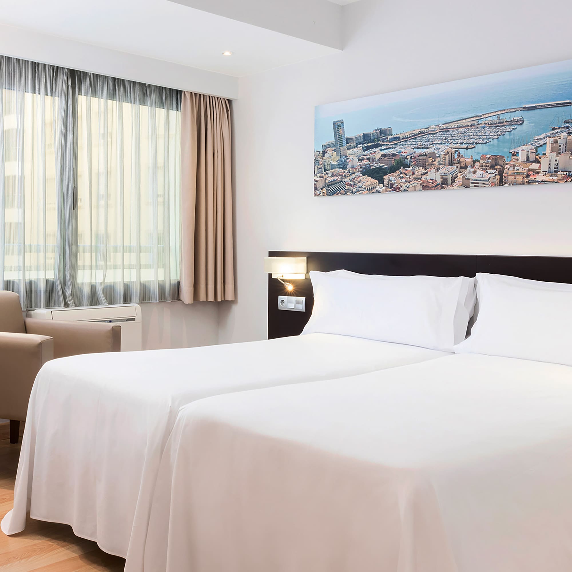 a room with two beds and a chair