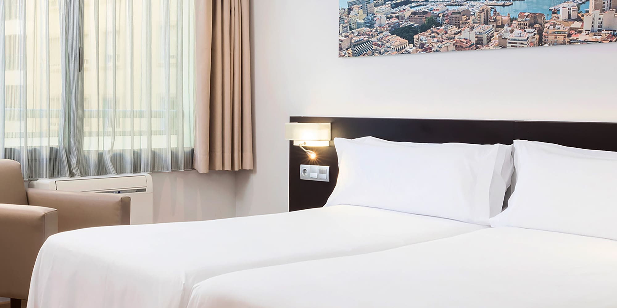 a room with two beds and a chair