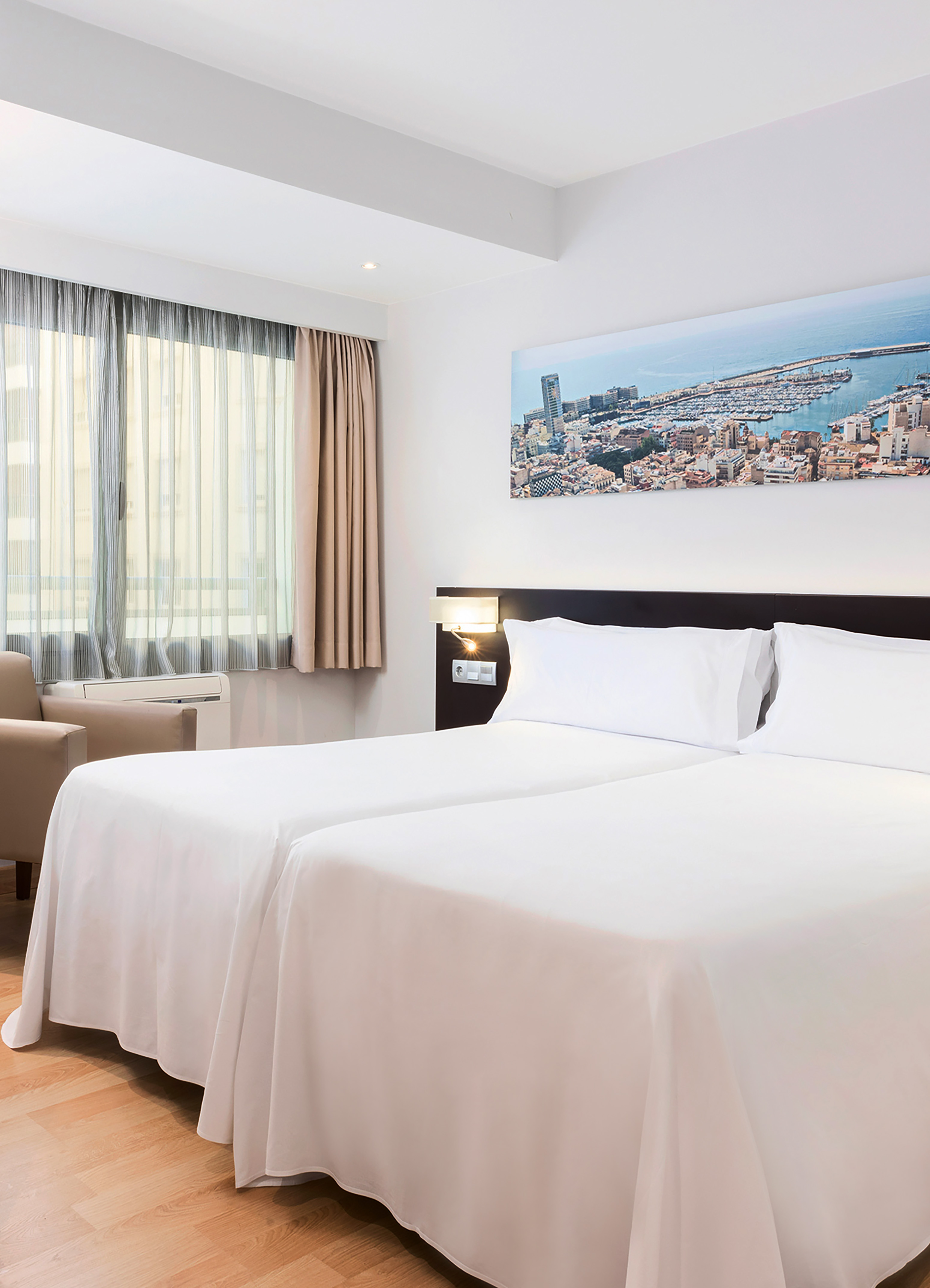 a room with two beds and a chair