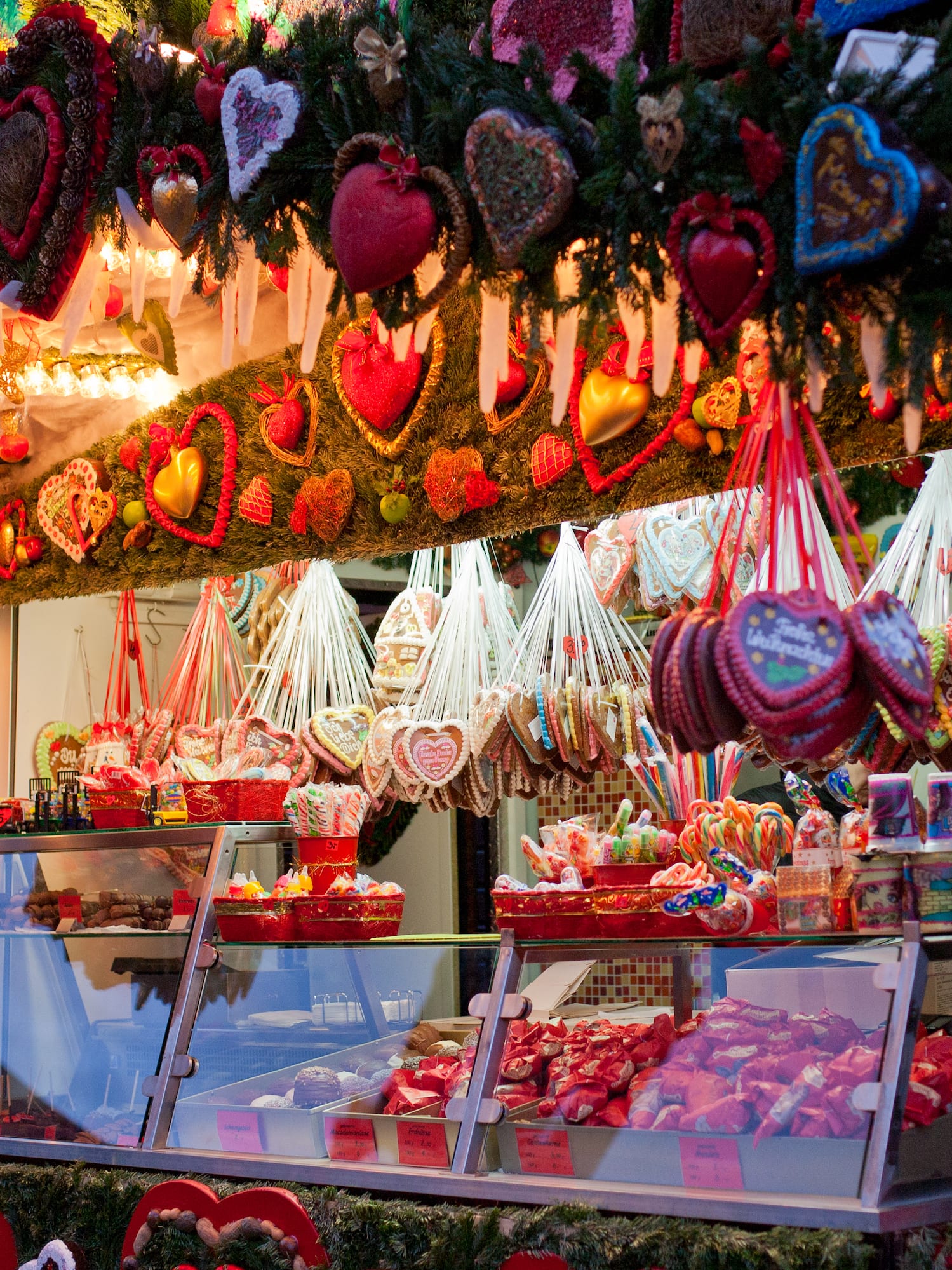 Festive Christmas market stall with gingerbread hearts and sweet treats.