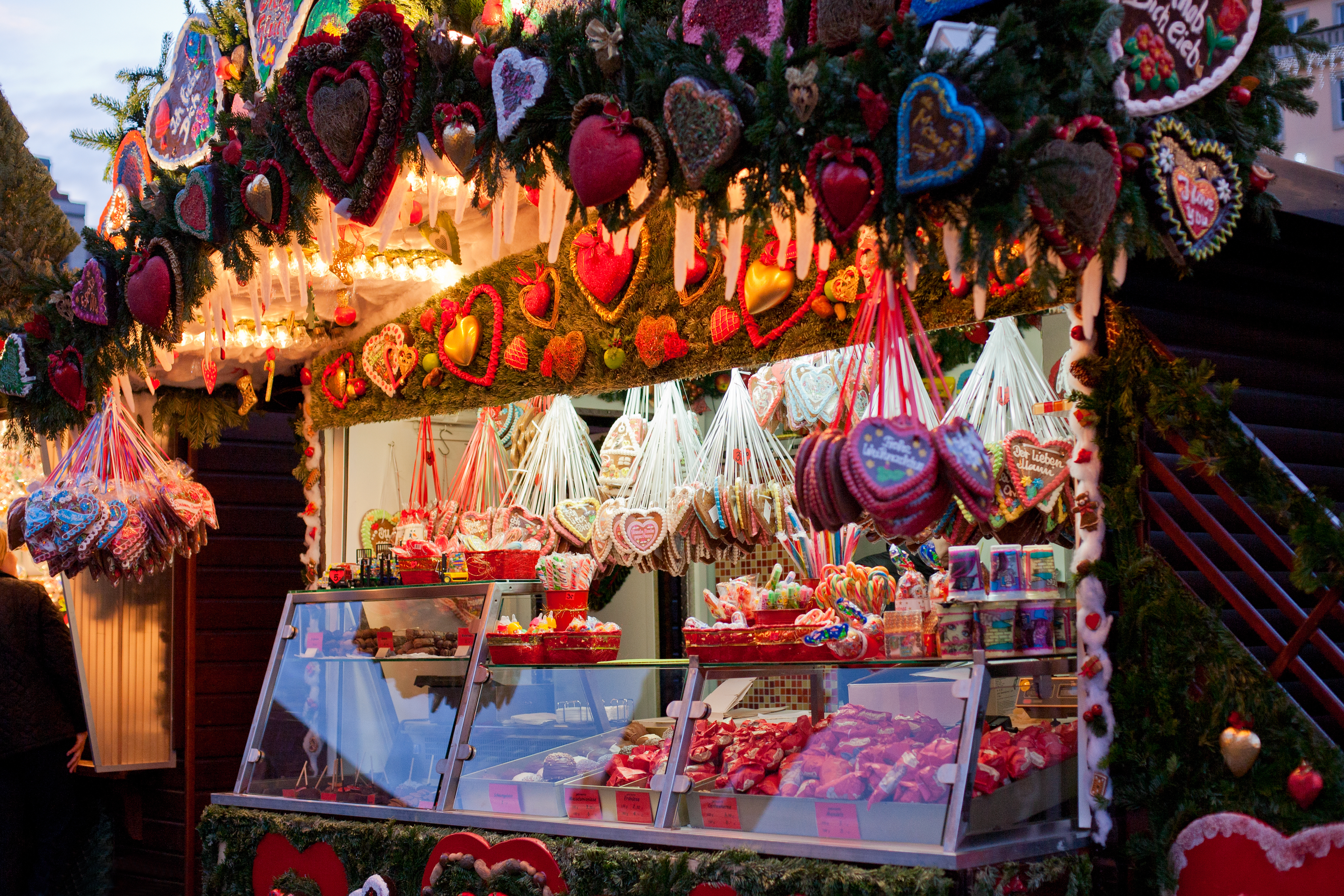 Festive Christmas market stall with gingerbread hearts and sweet treats.