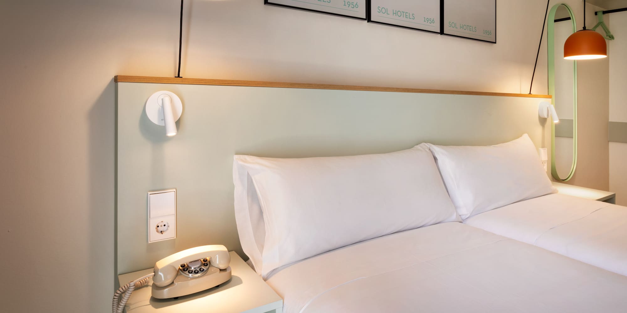 a bed with a telephone on a table