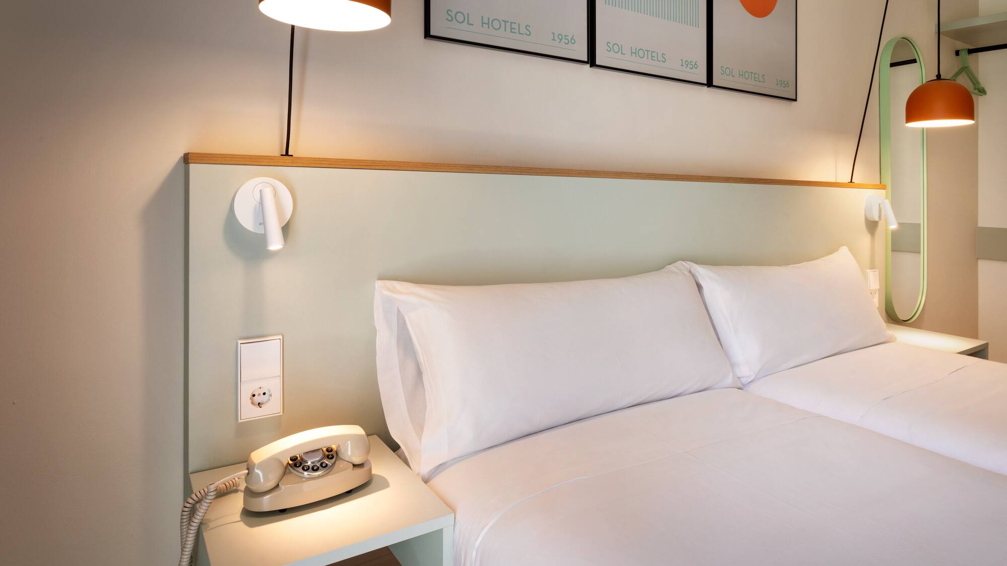 a bed with a telephone on a table