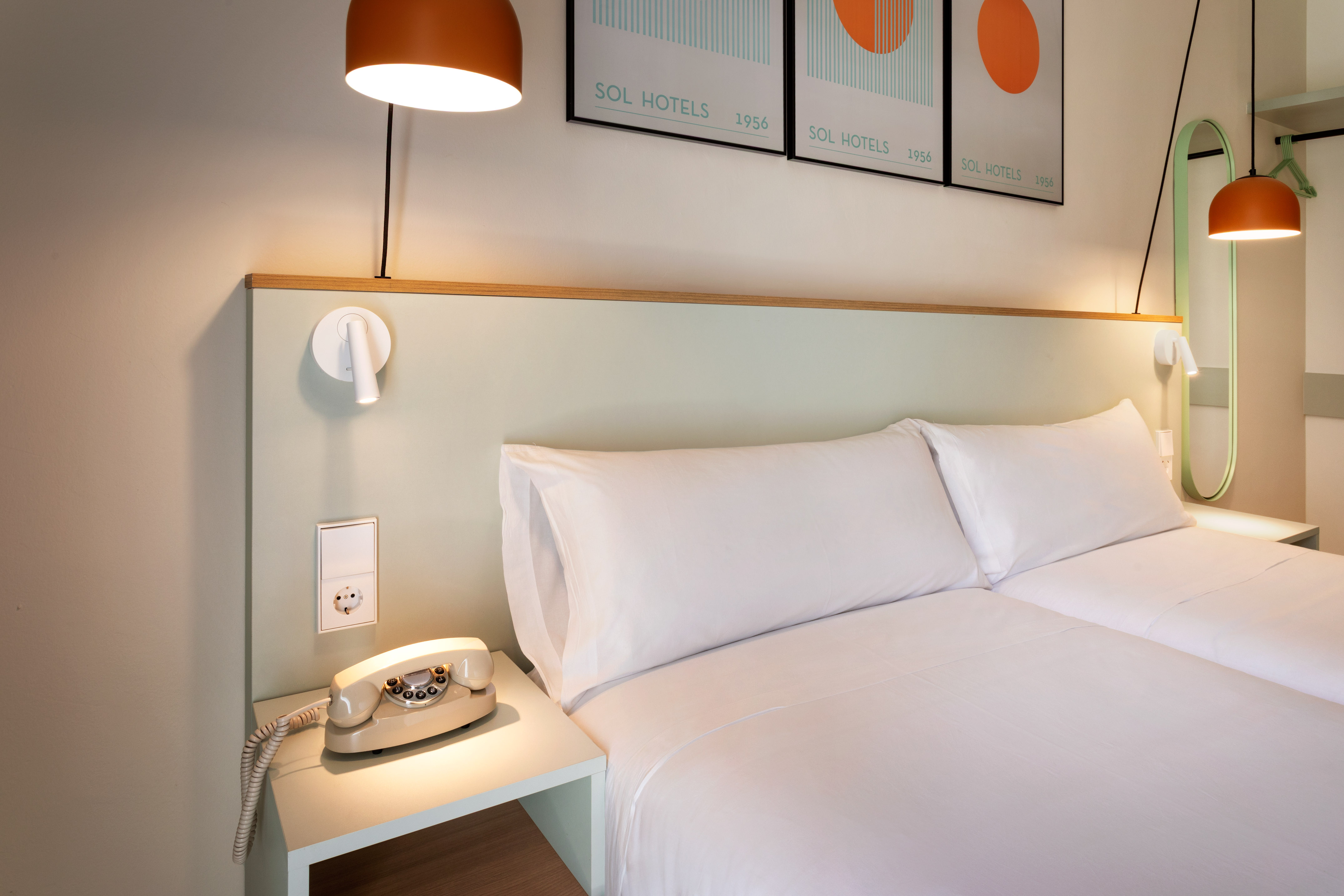 a bed with a telephone on a table