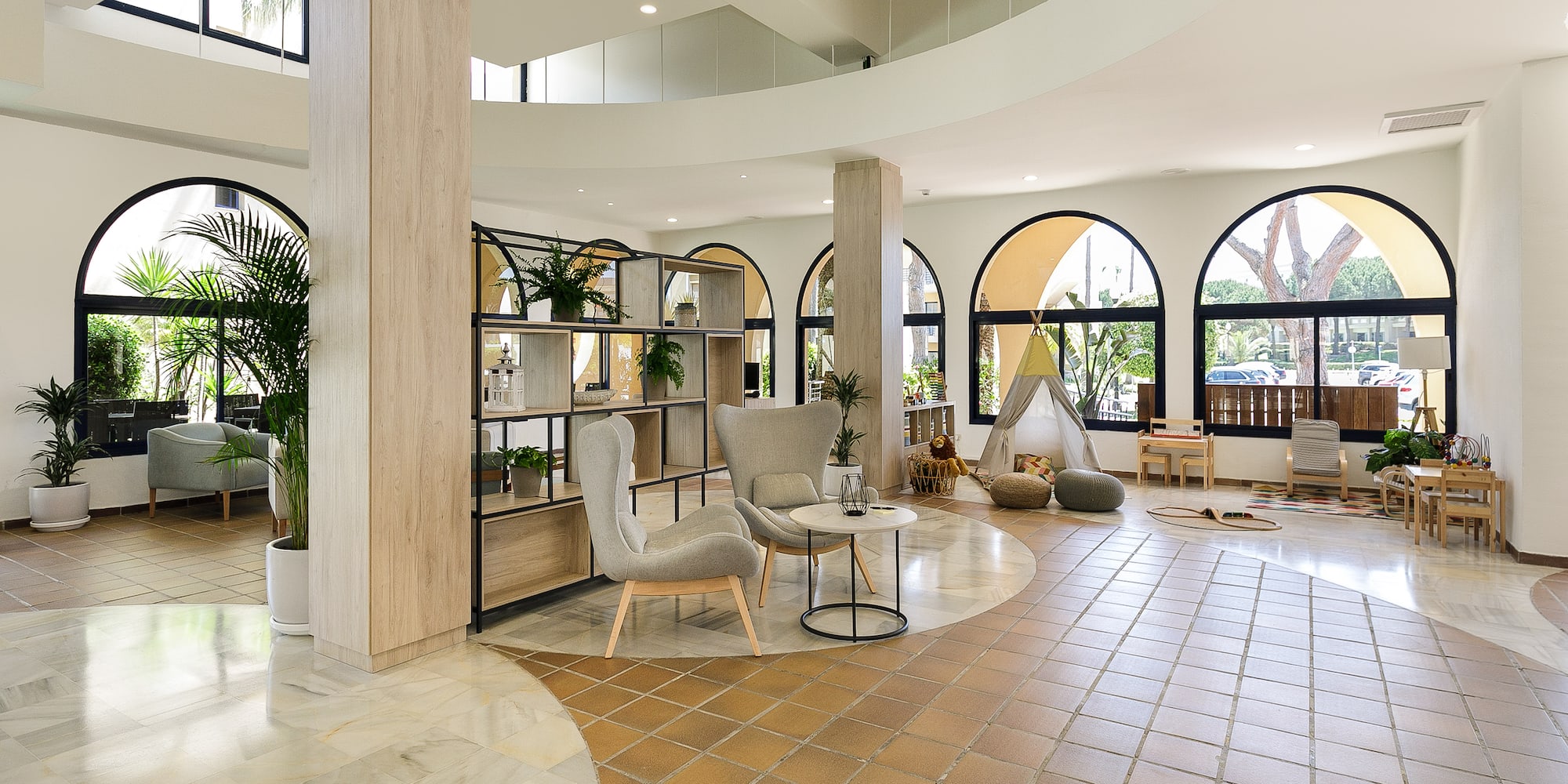 a room with a large round table and chairs