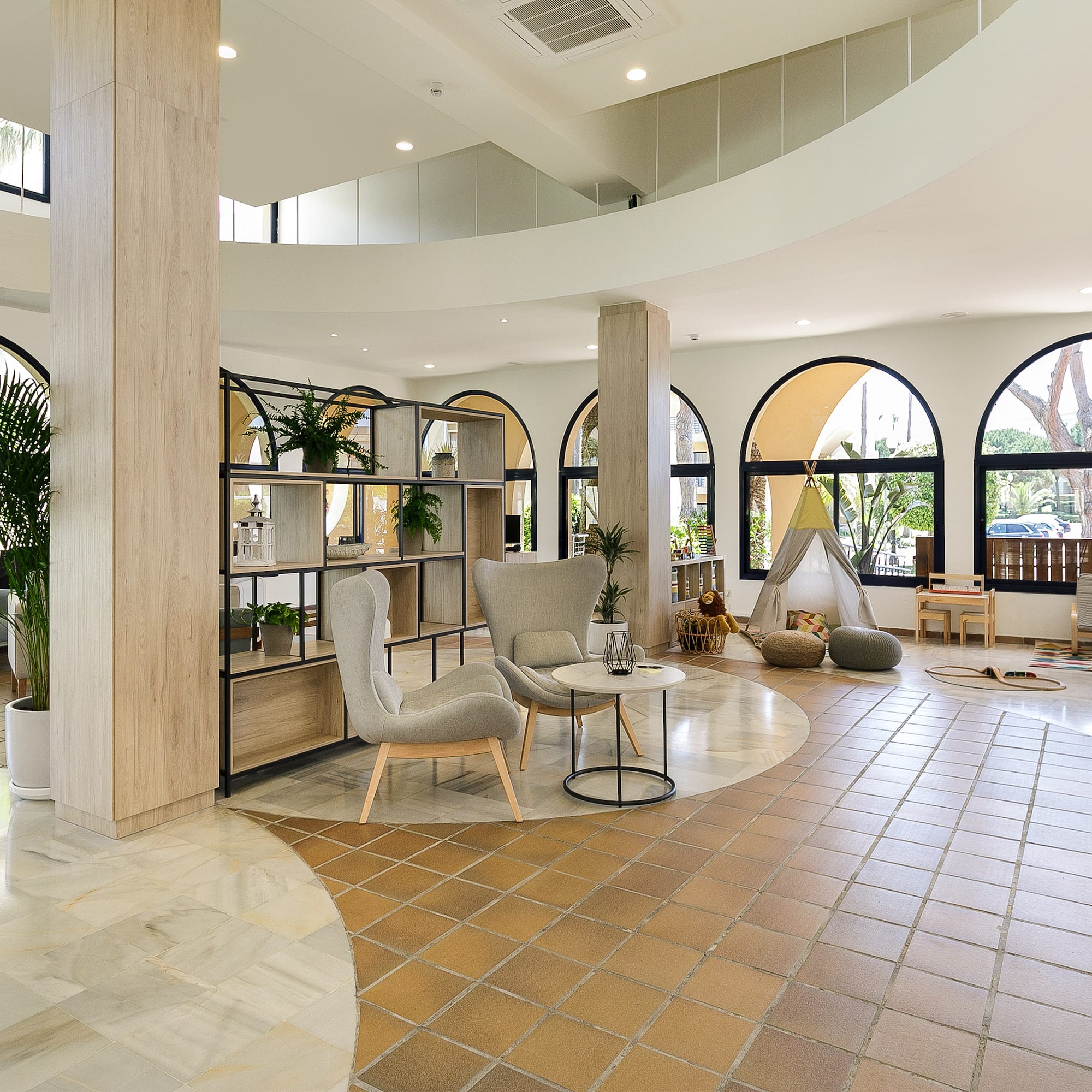 a room with a large round table and chairs
