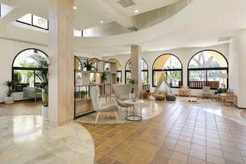 a room with a large round table and chairs
