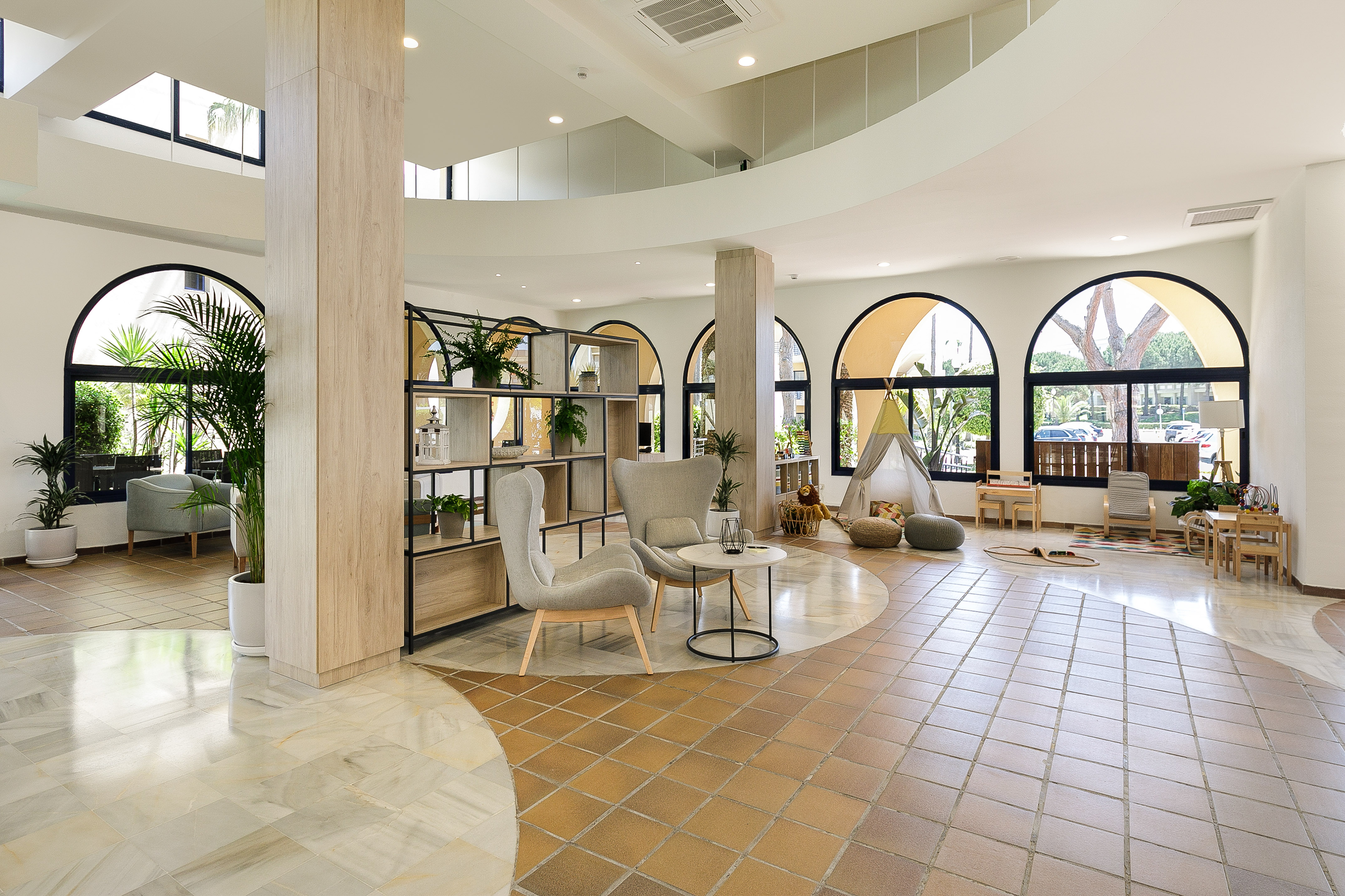 a room with a large round table and chairs