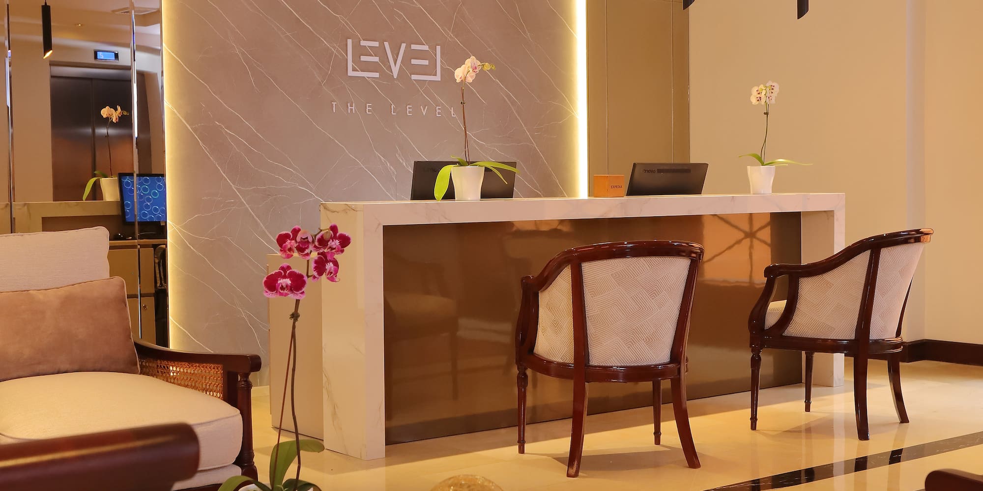 a lobby with chairs and a reception desk