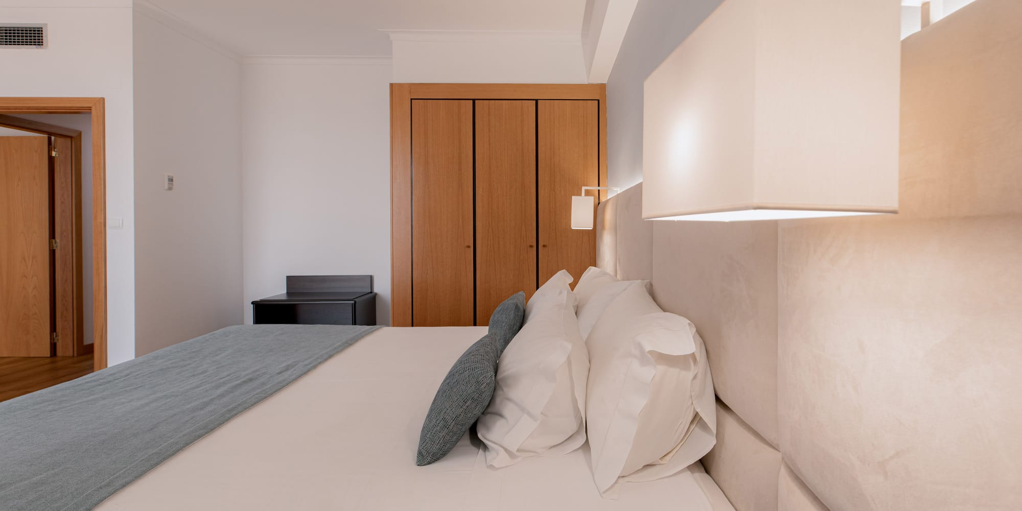 a bed with a lamp and a closet