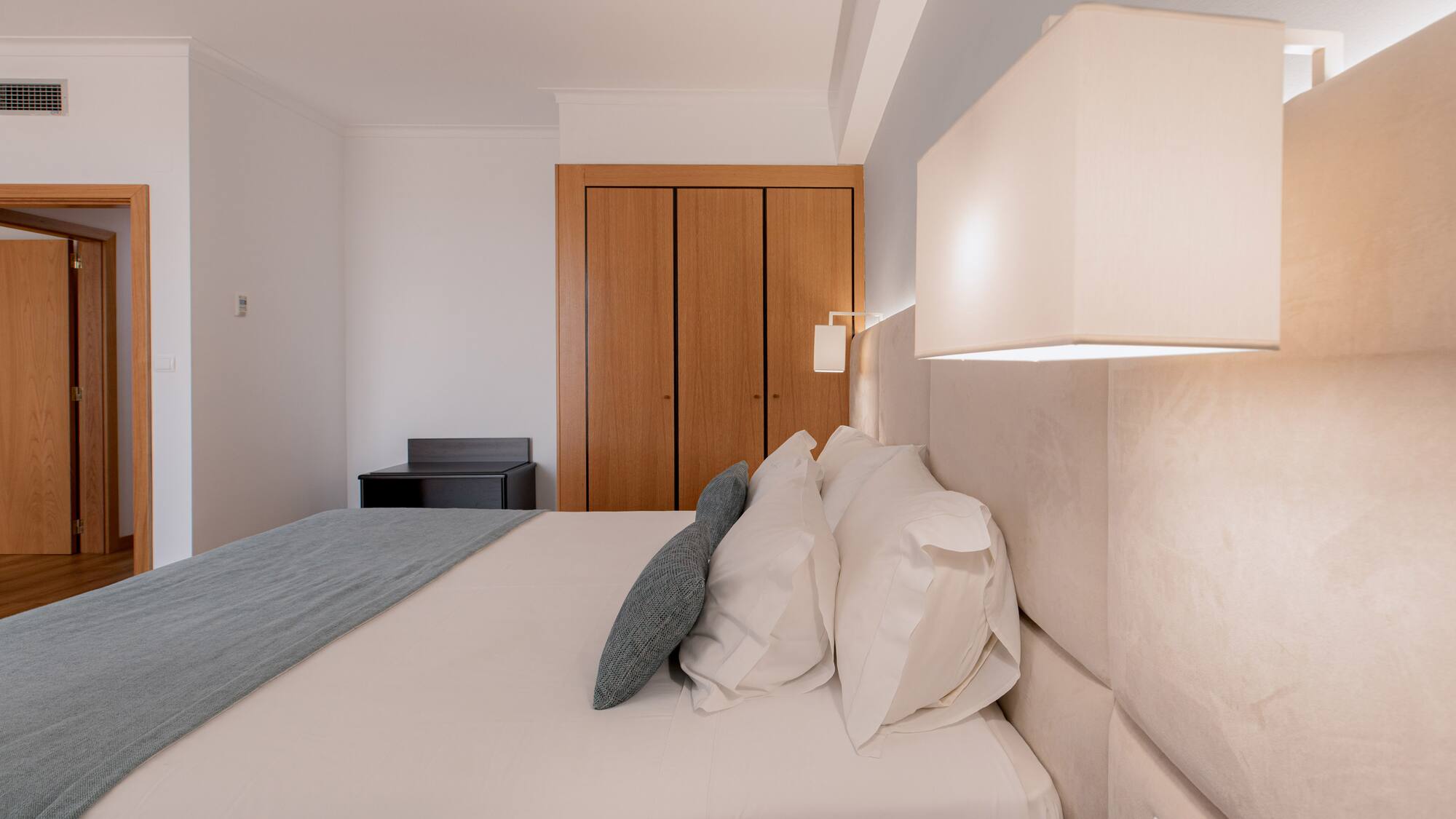 a bed with a lamp and a closet