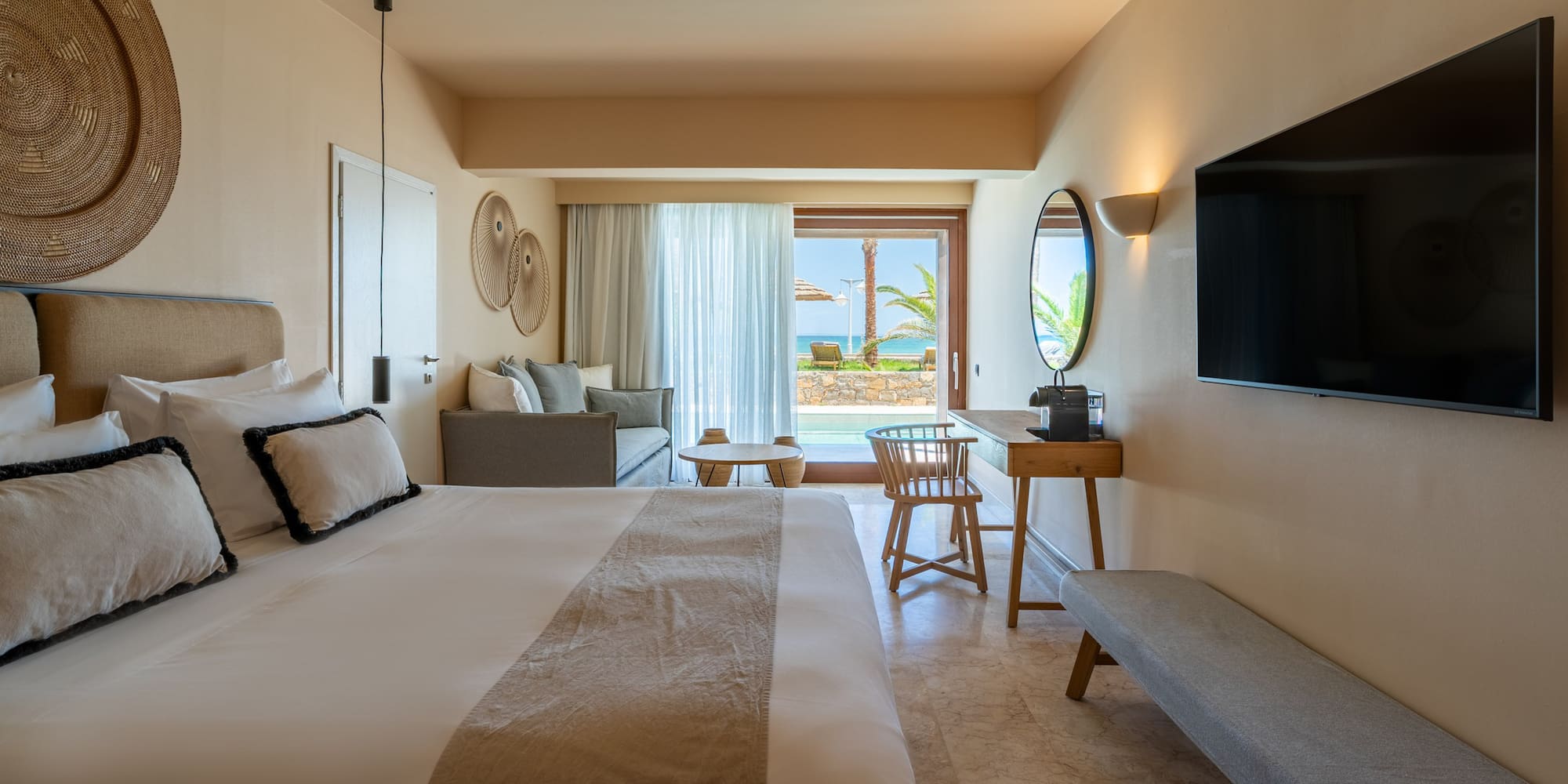 Resort room with private pool, ocean view, king bed, and lounge area.