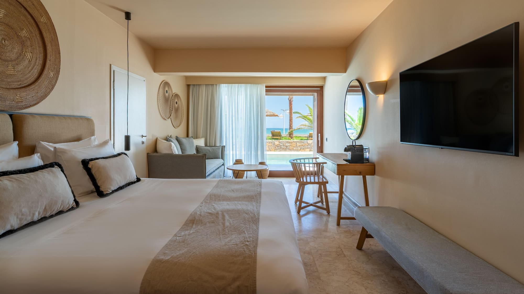 Resort room with private pool, ocean view, king bed, and lounge area.