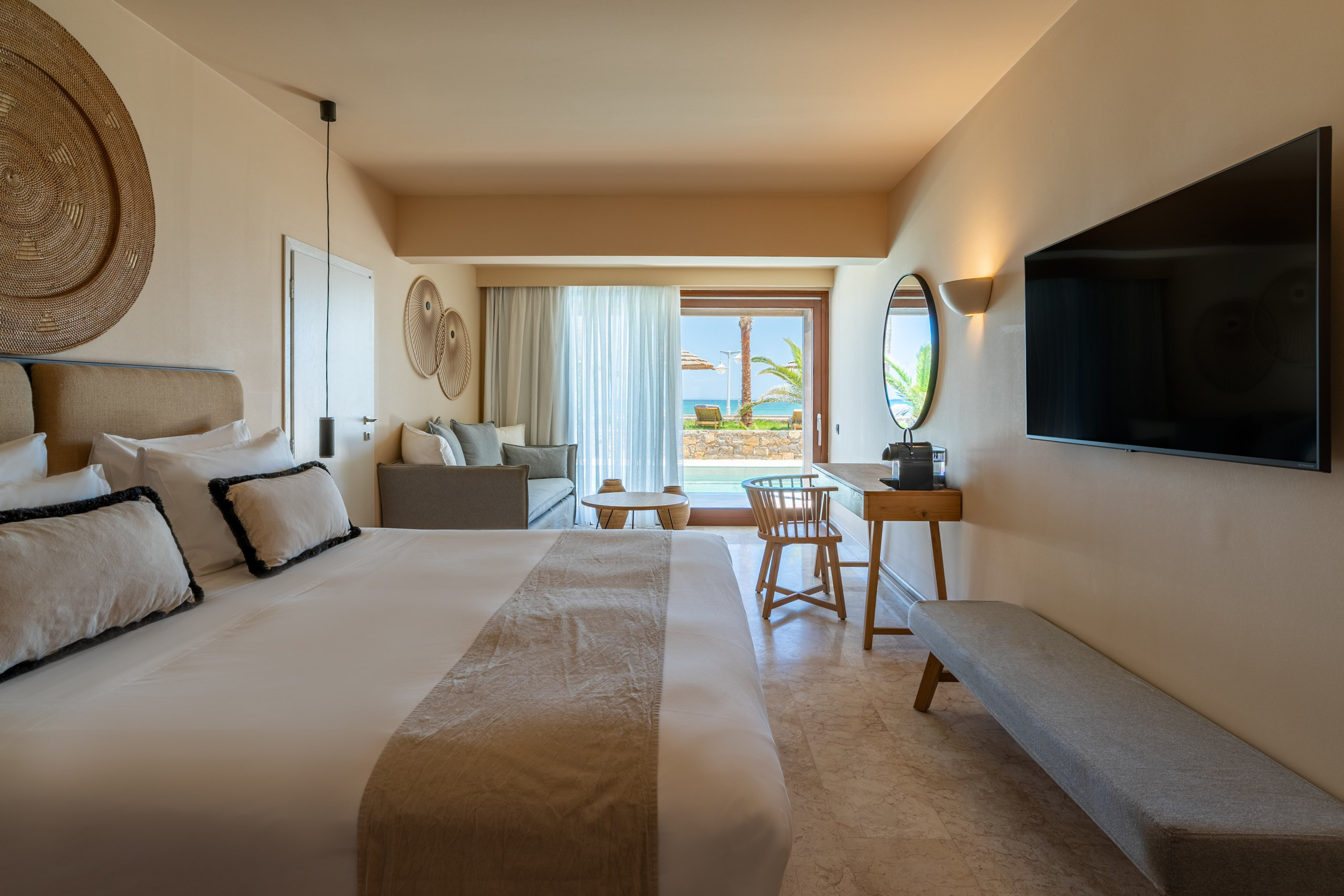 Resort room with private pool, ocean view, king bed, and lounge area.