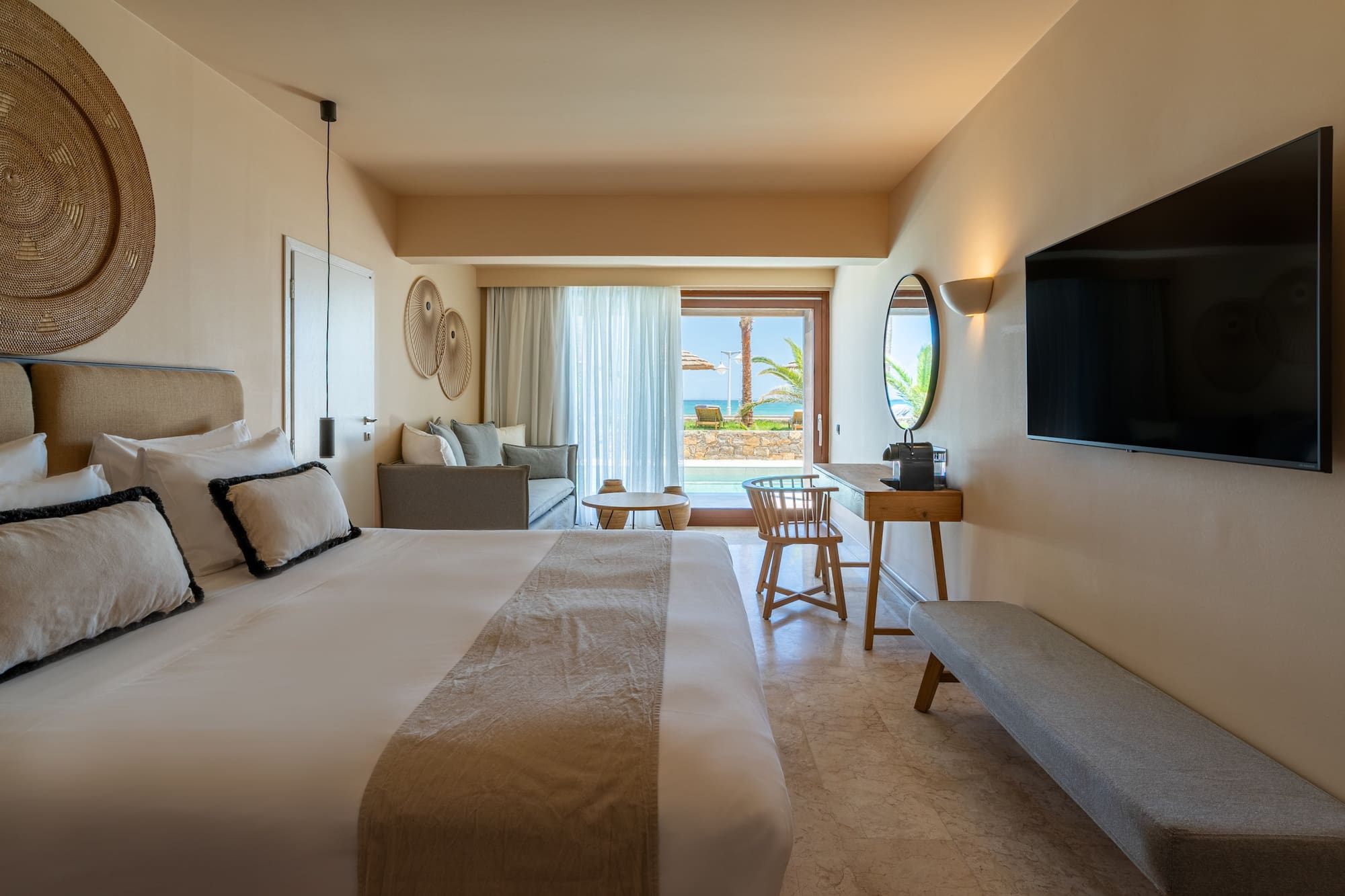 Resort room with private pool, ocean view, king bed, and lounge area.