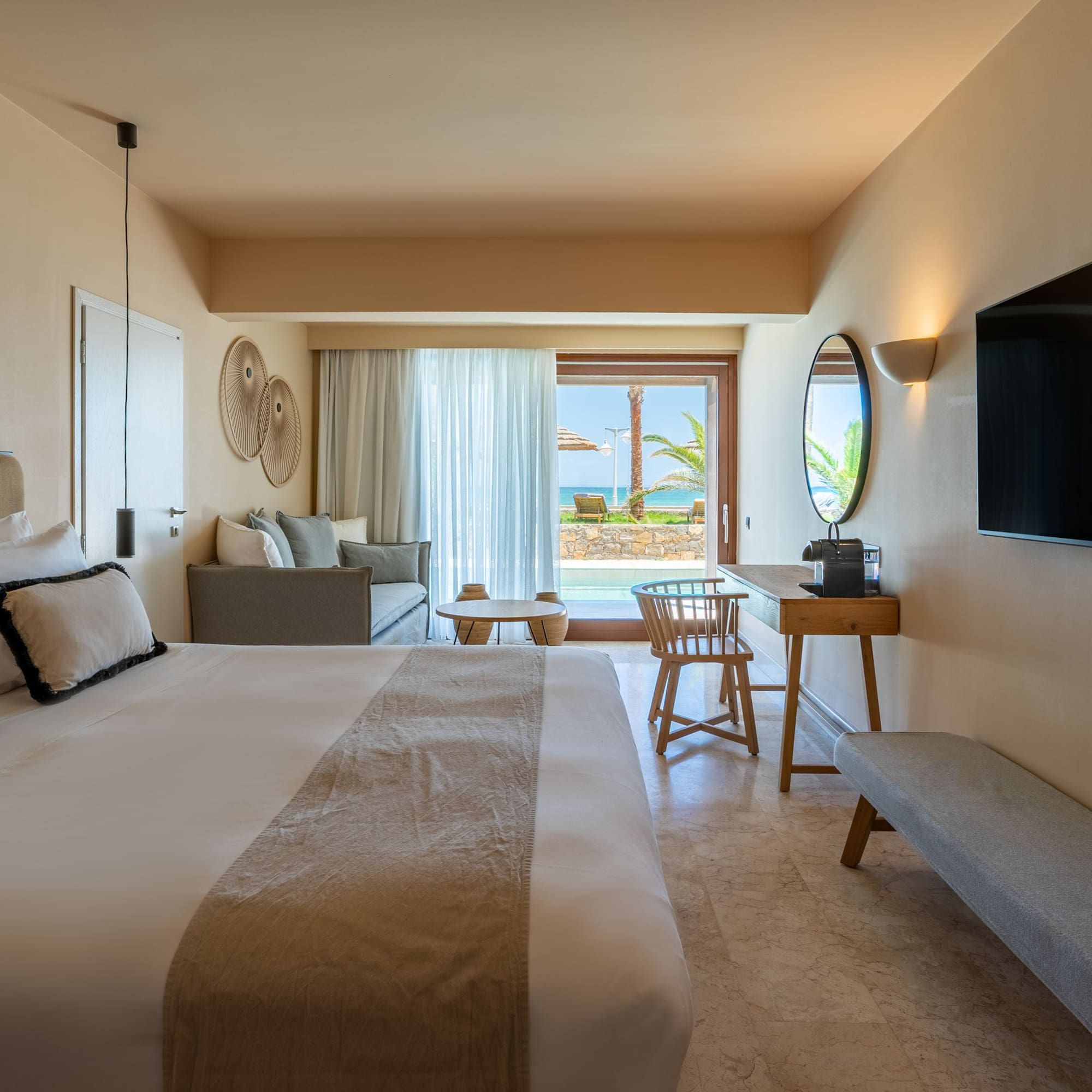 Resort room with private pool, ocean view, king bed, and lounge area.