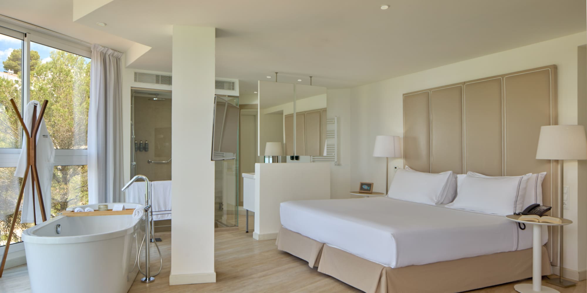 a room with a large bed and a tub