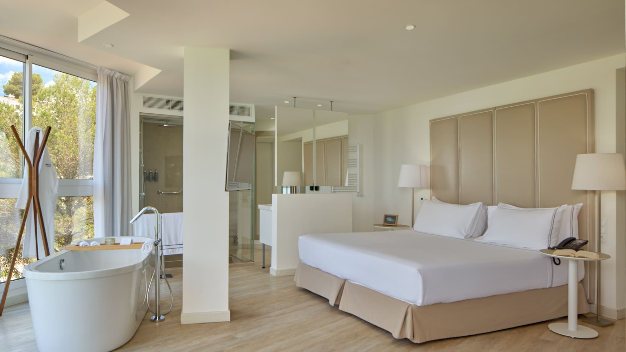 a room with a large bed and a tub