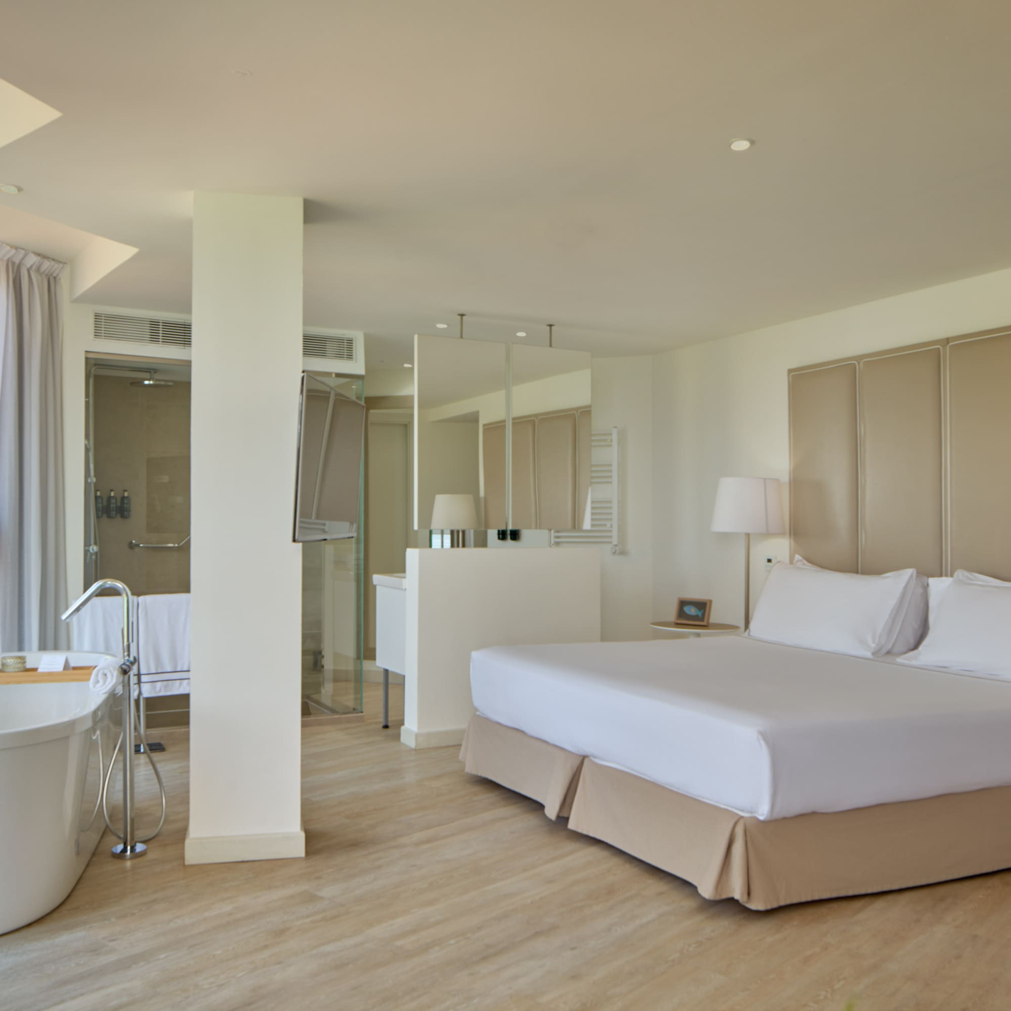 a room with a large bed and a tub