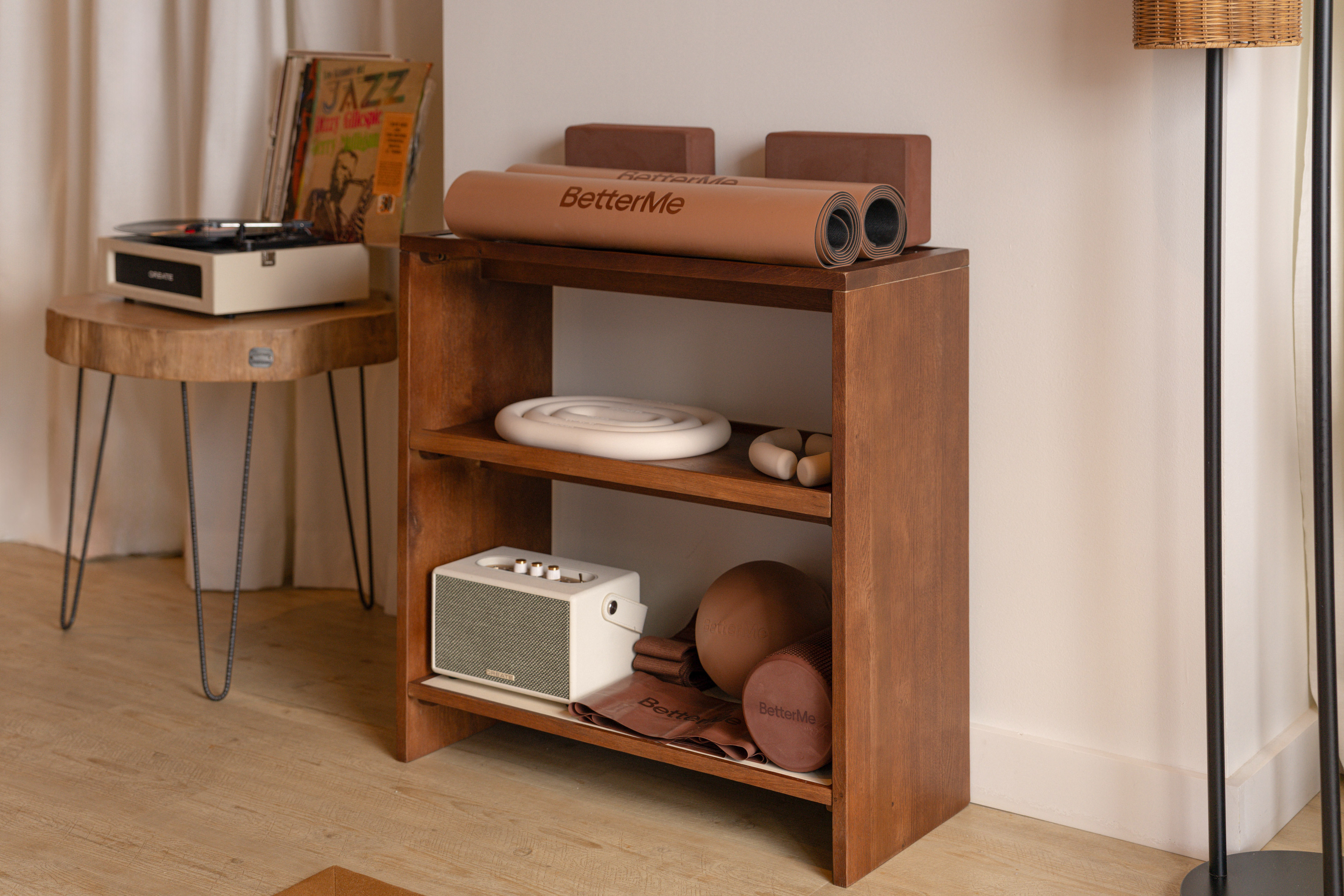 BetterMe yoga mats, blocks, and home workout gear on a wooden shelf.