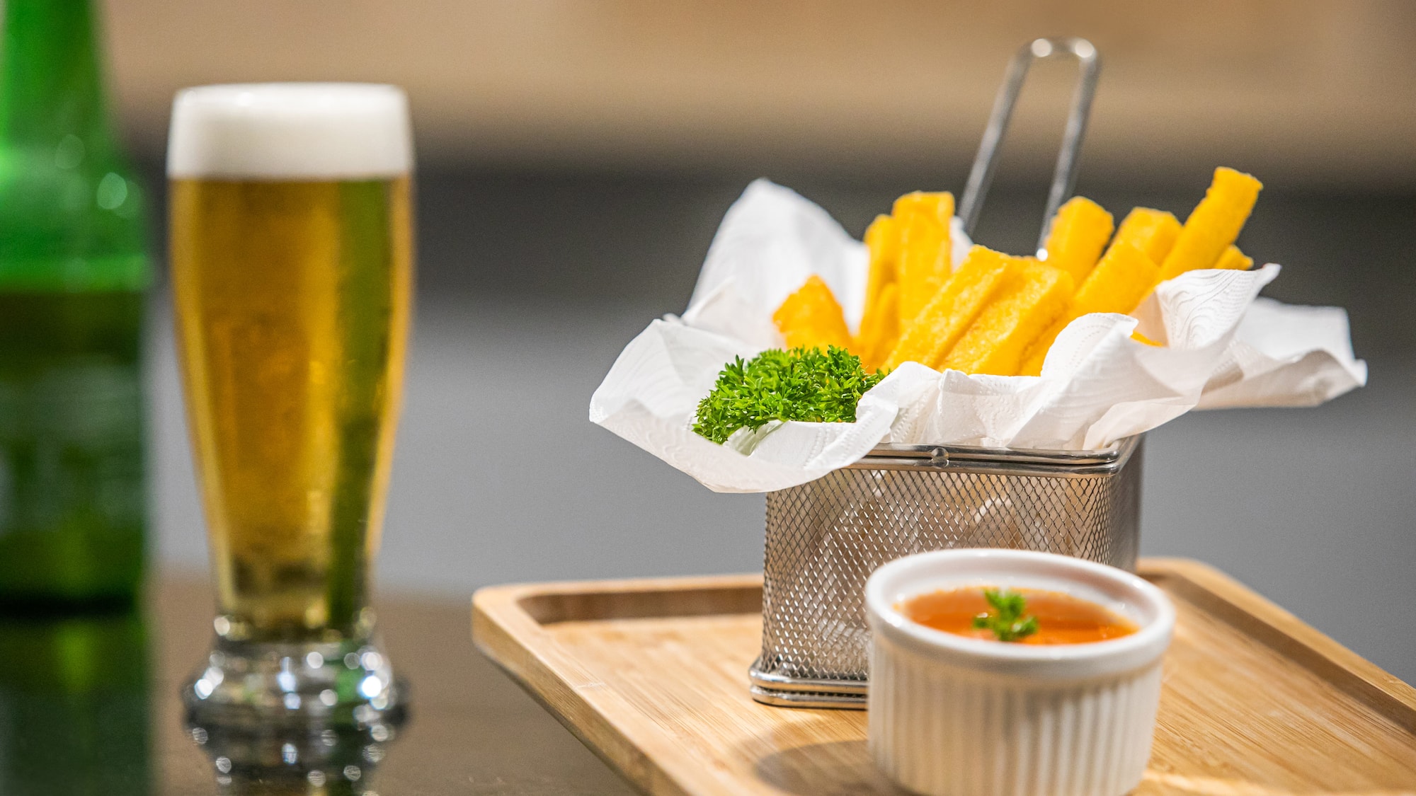 a basket of fries and sauce on a tray