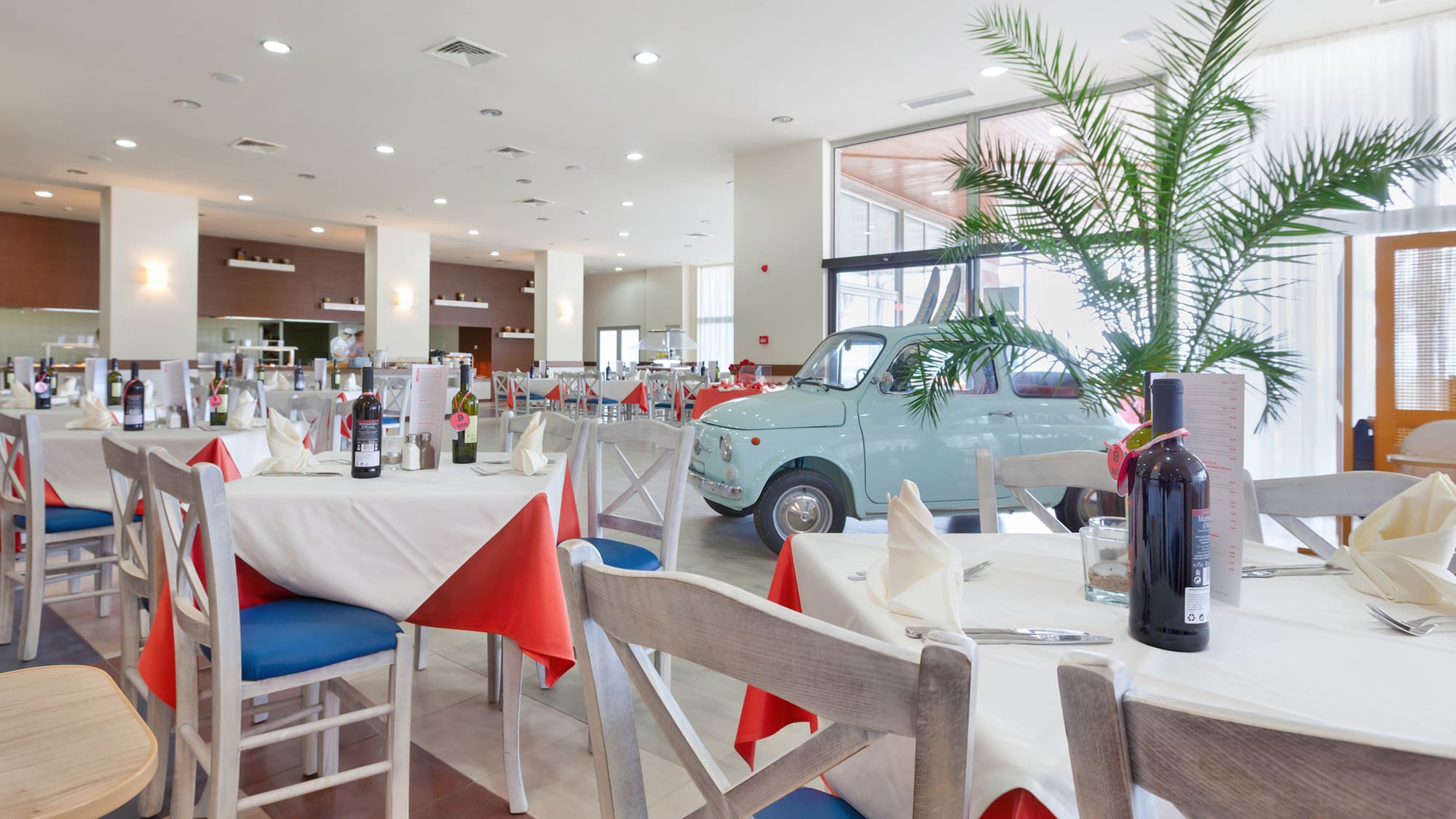 a room with tables and chairs and a car