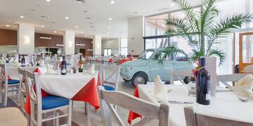 a room with tables and chairs and a car