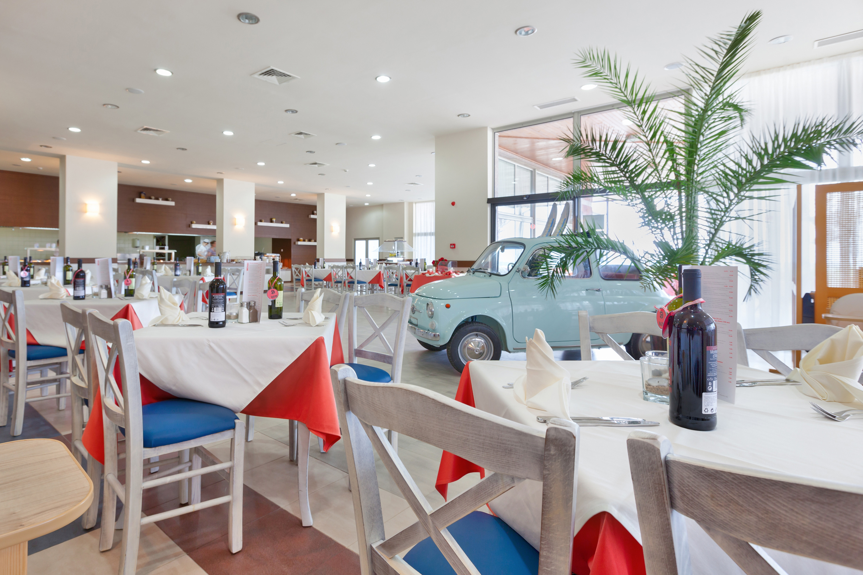 a room with tables and chairs and a car