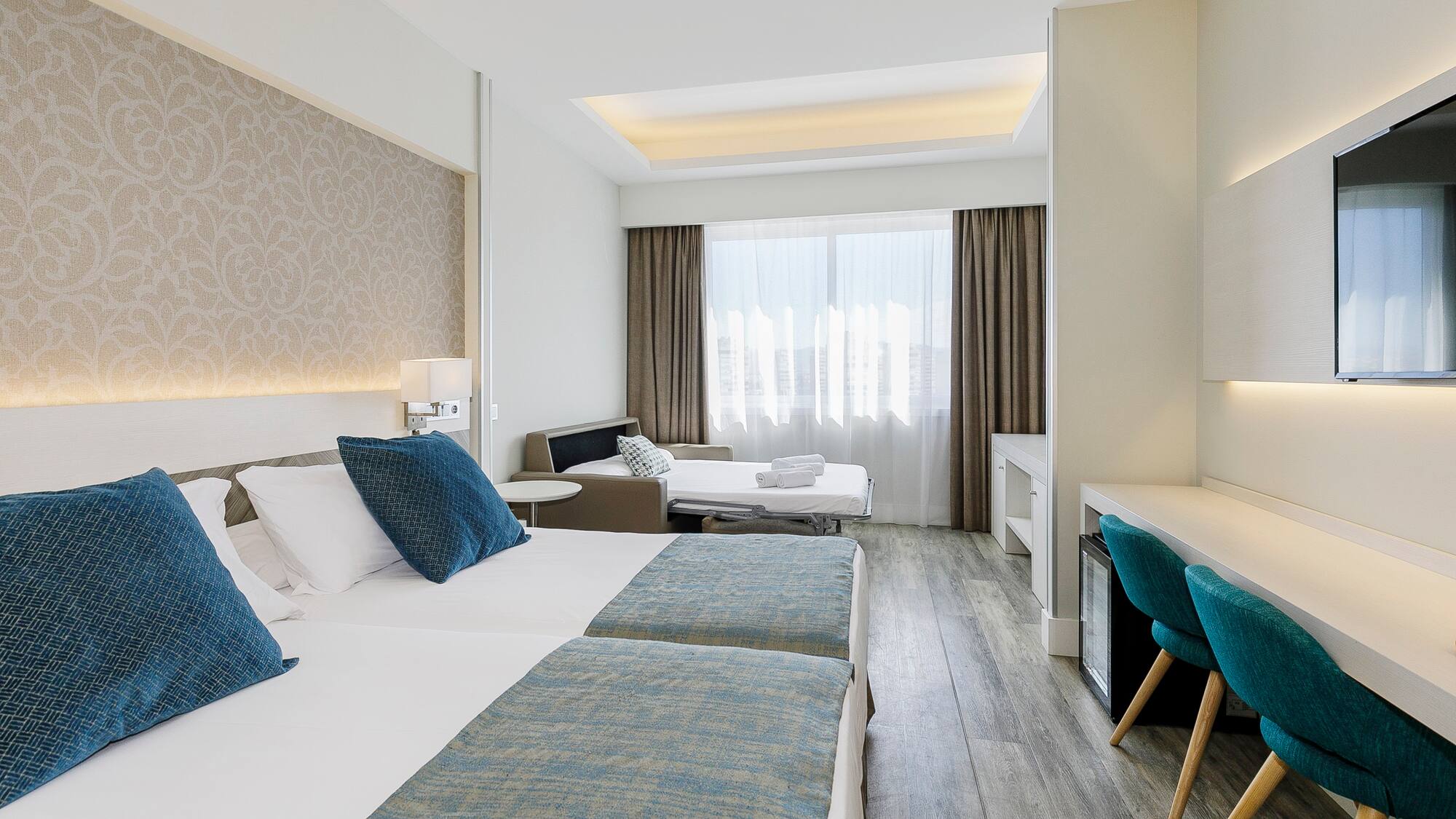 a room with two beds and a table