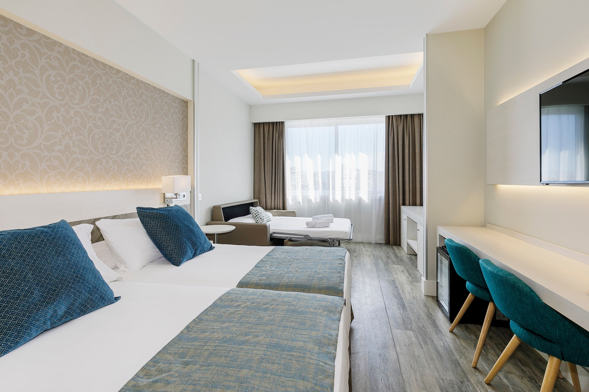 a room with two beds and a table