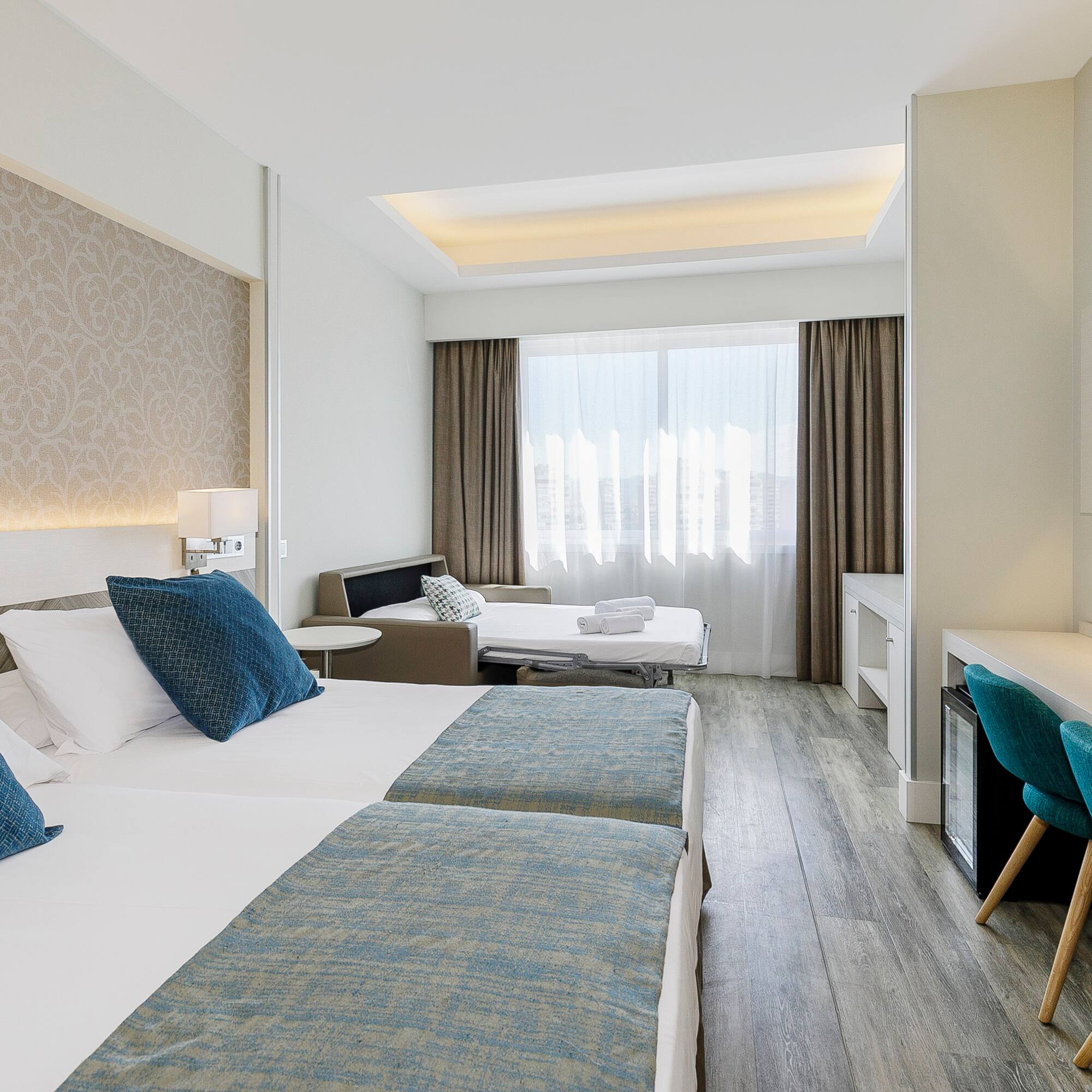 a room with two beds and a table