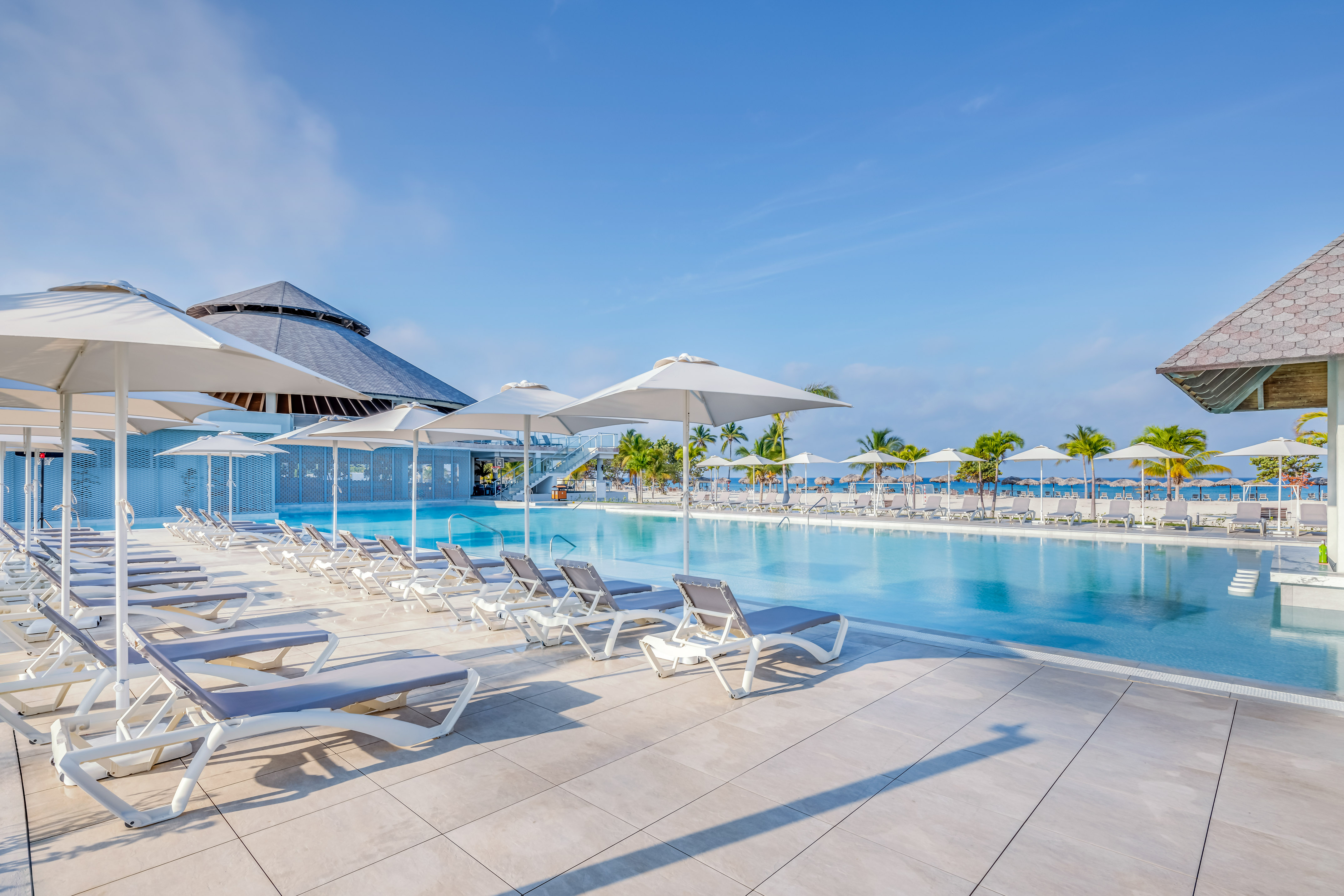 a pool with lounge chairs and umbrellas
