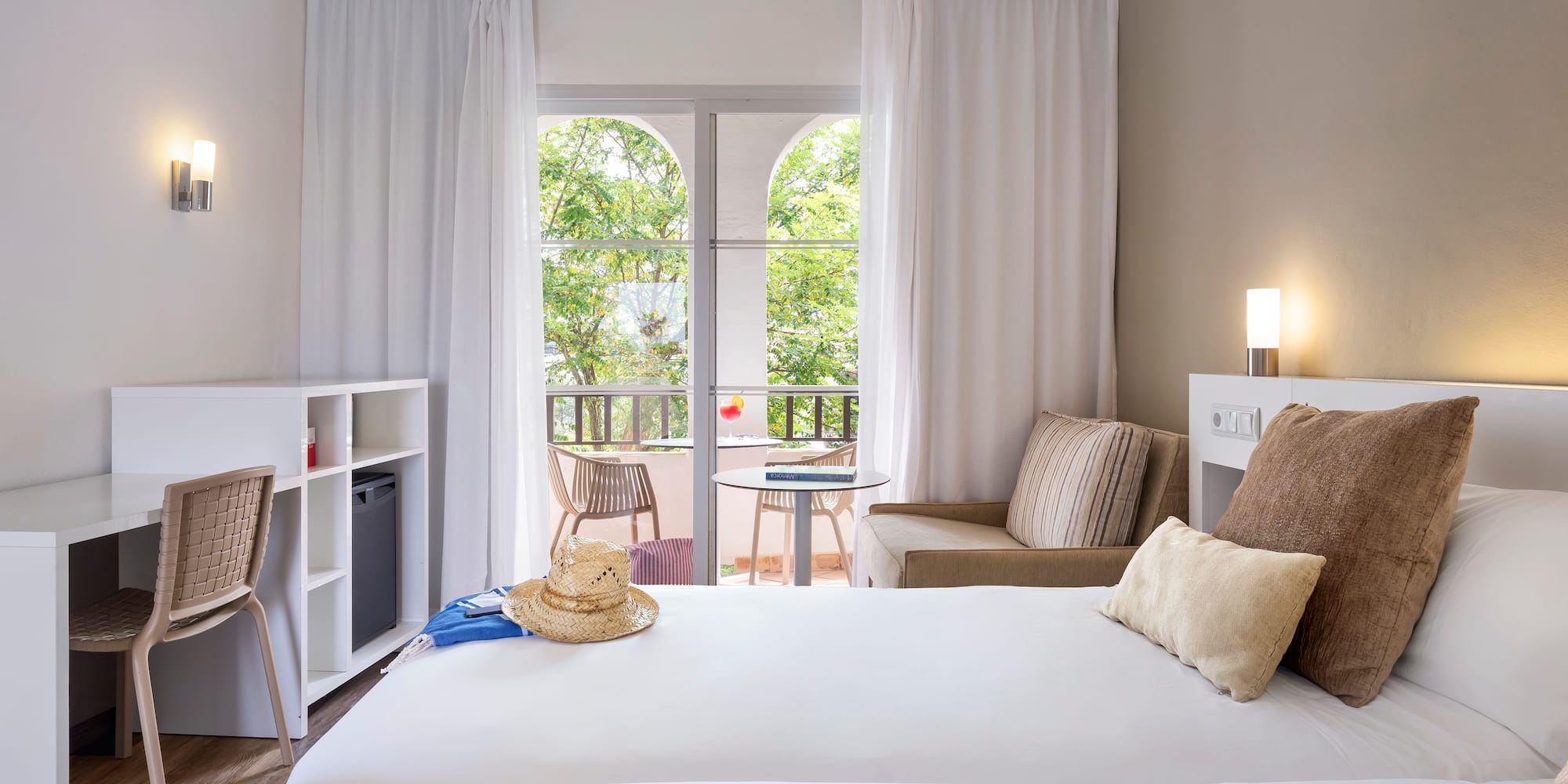 a room with two beds and a chair and a table