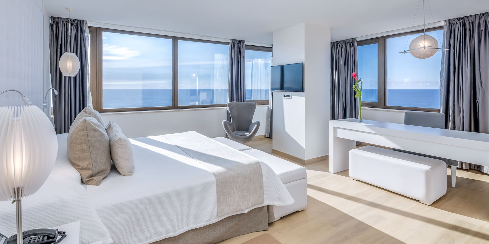 a bedroom with a large bed and a television