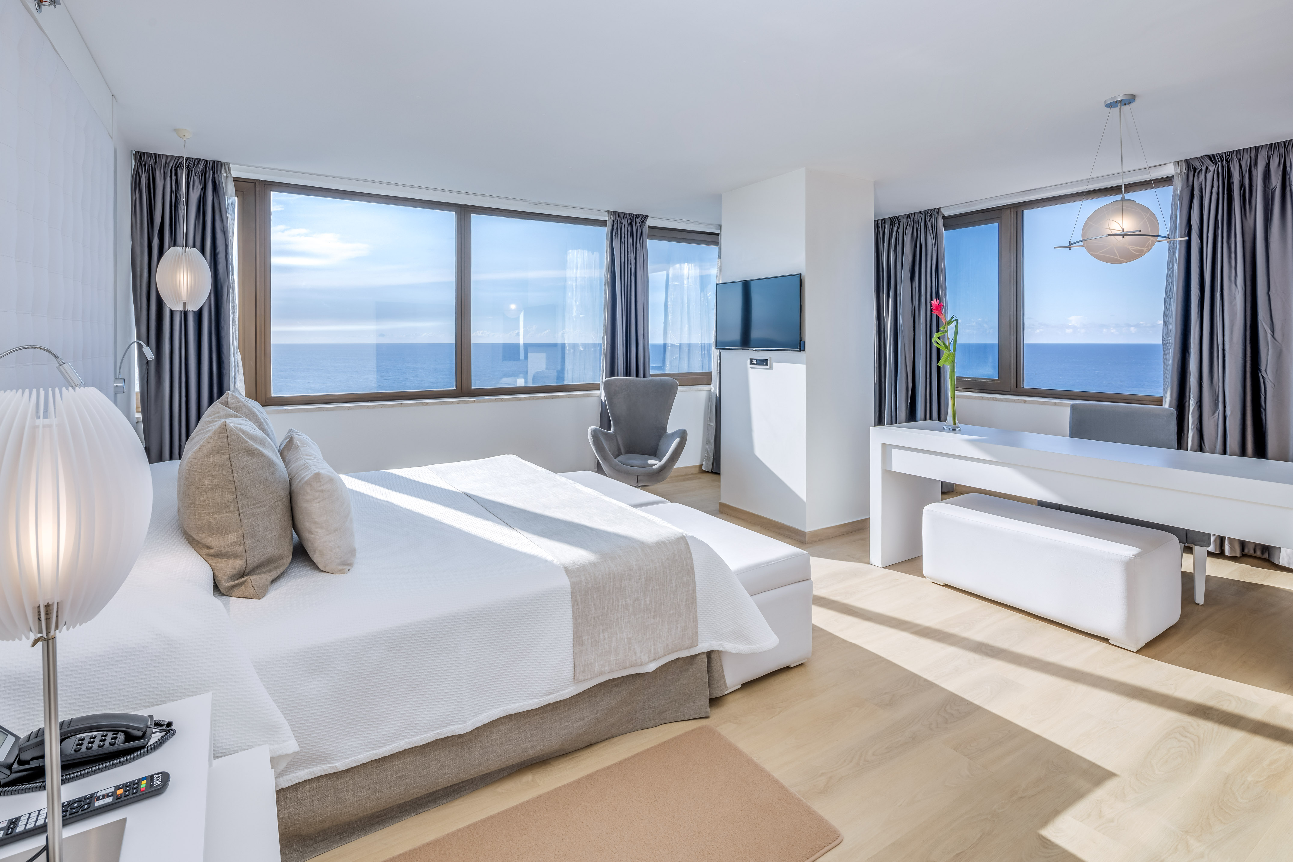 a bedroom with a large bed and a television