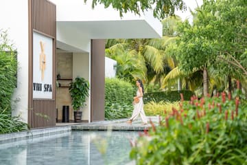 a woman walking by a pool
