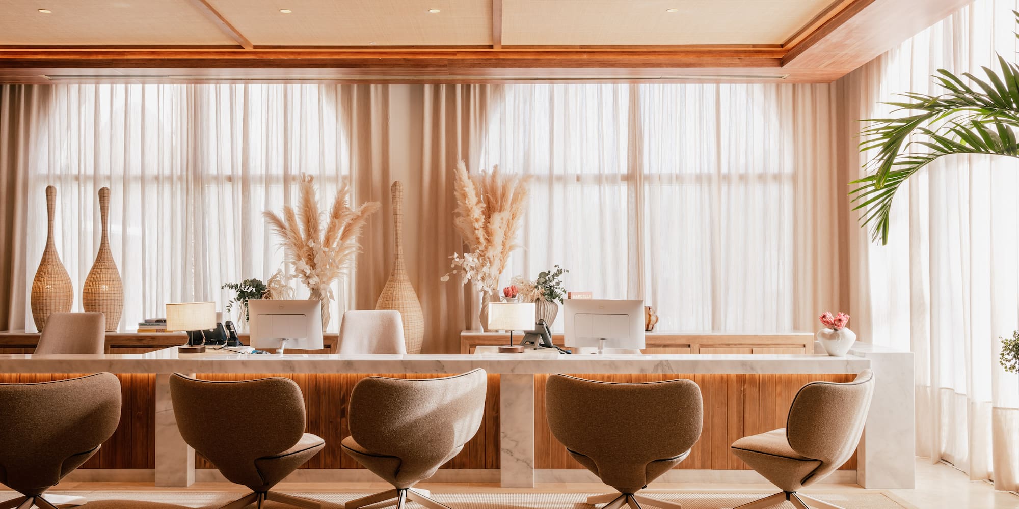 a room with a desk and chairs