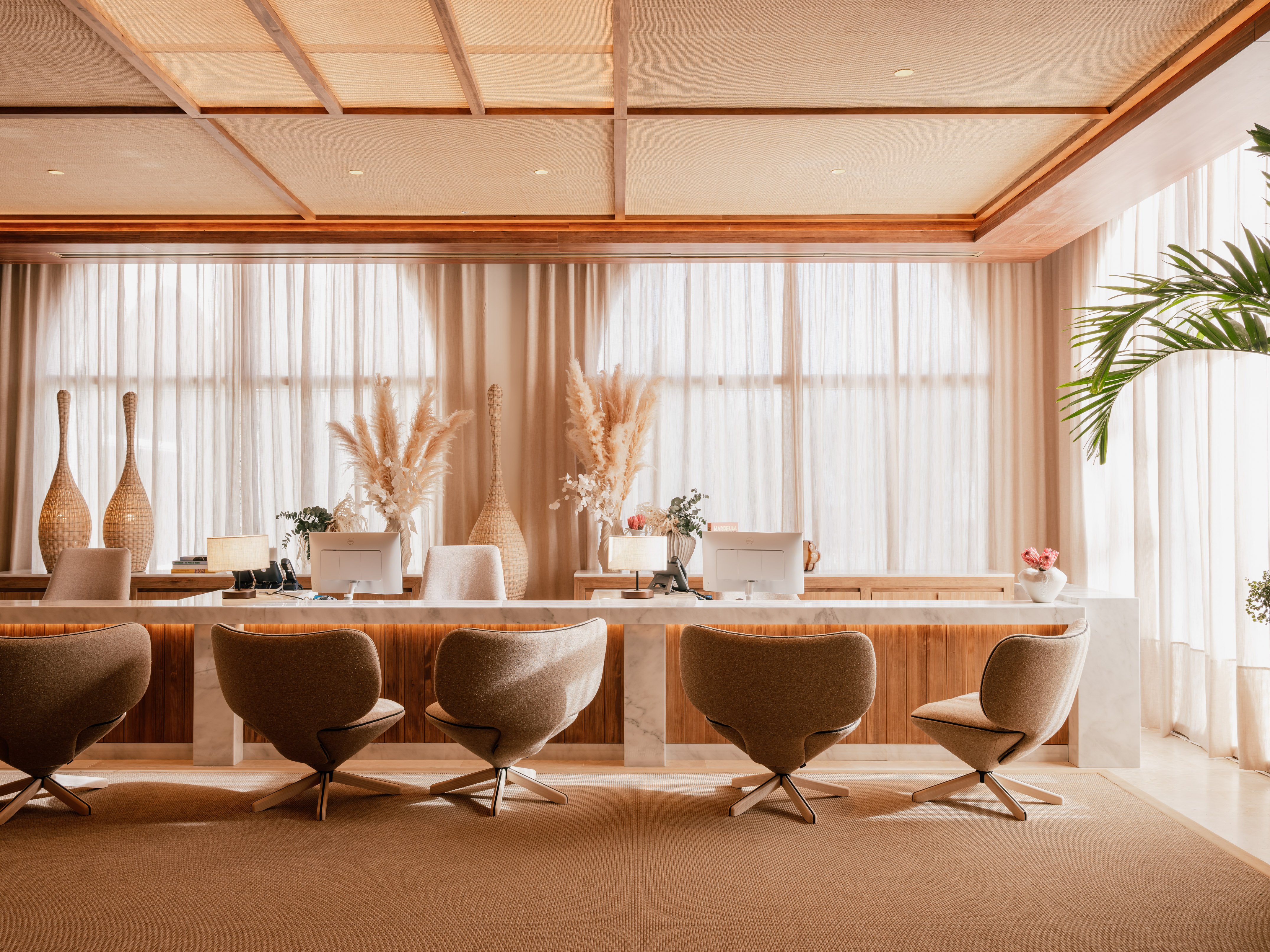 a room with a desk and chairs