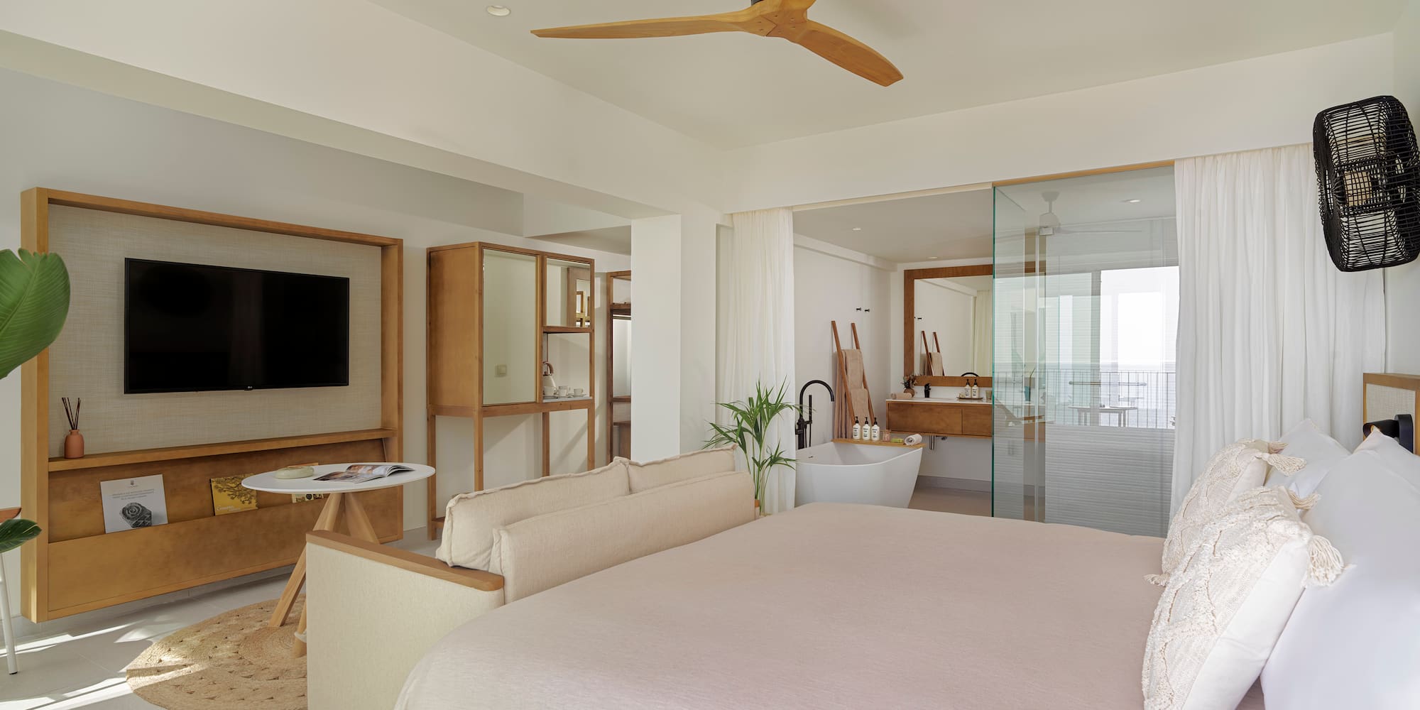 a bedroom with a large bed and a television