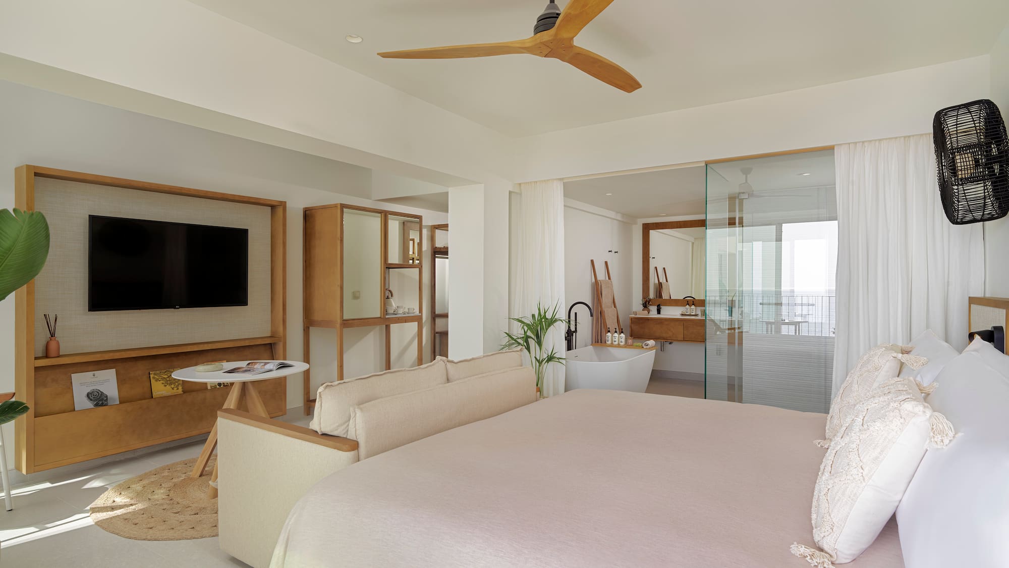 a bedroom with a large bed and a television