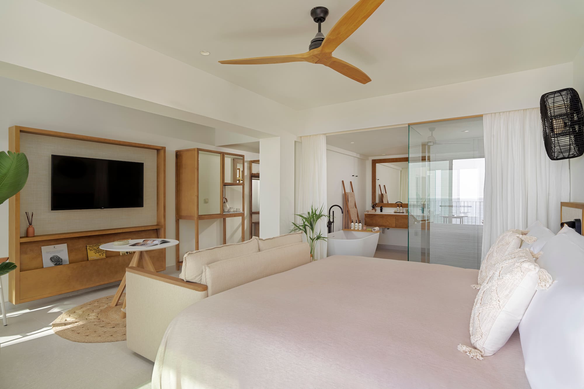 a bedroom with a large bed and a television