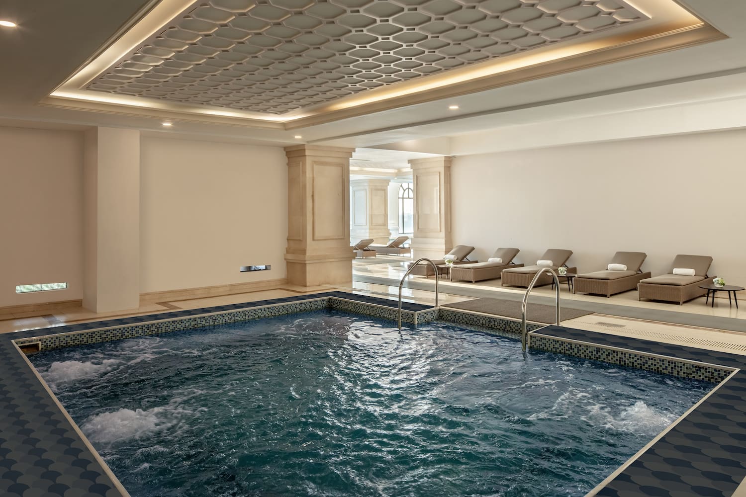 a indoor pool with a large tub