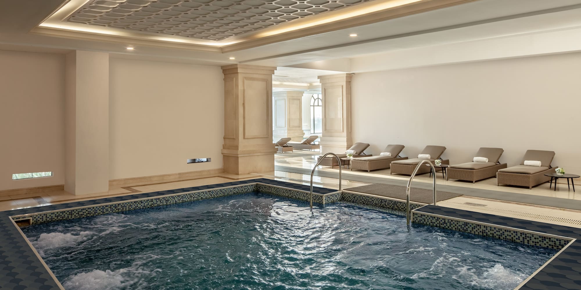 a indoor pool with a large tub