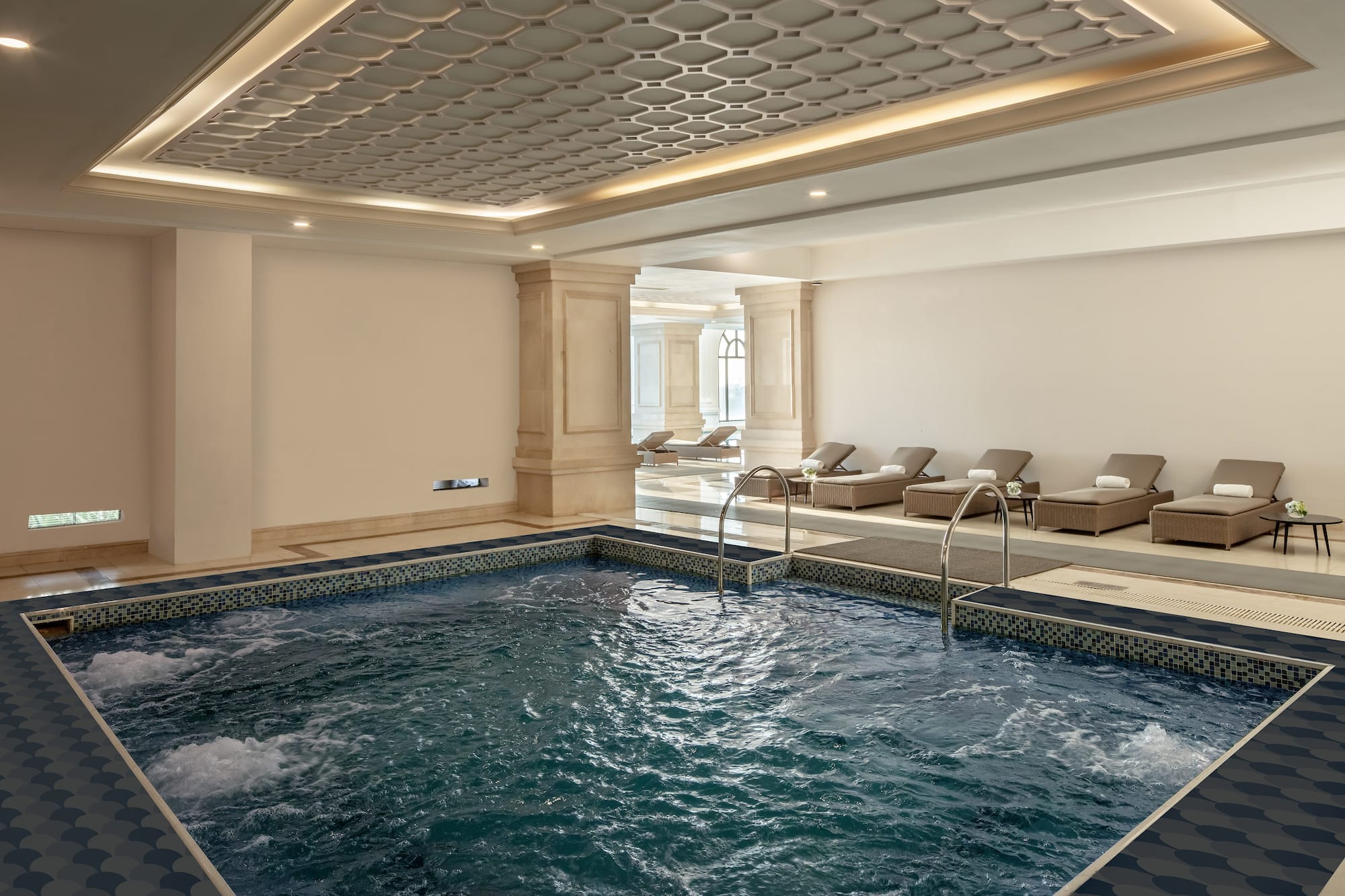 a indoor pool with a large tub