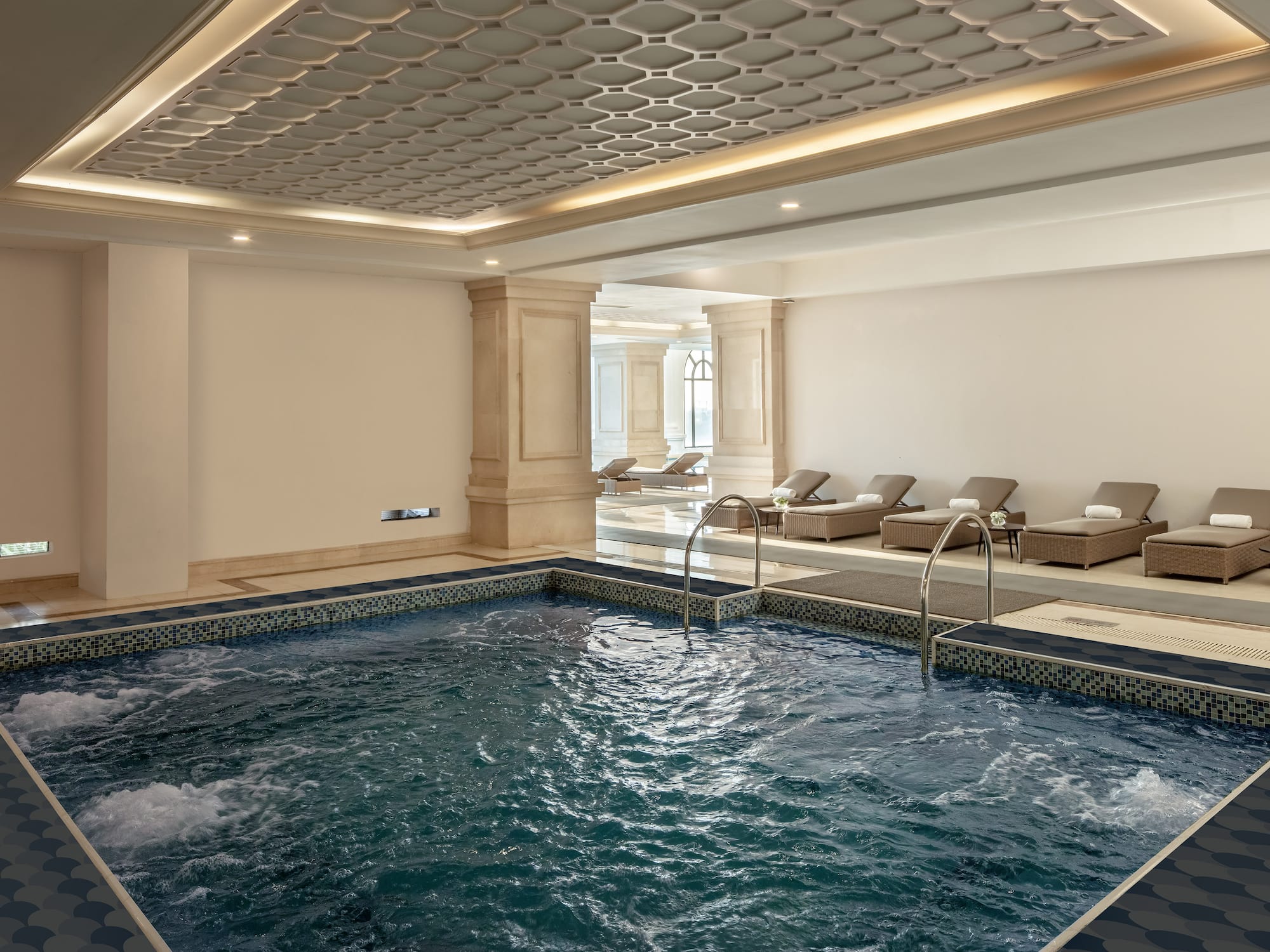 a indoor pool with a large tub