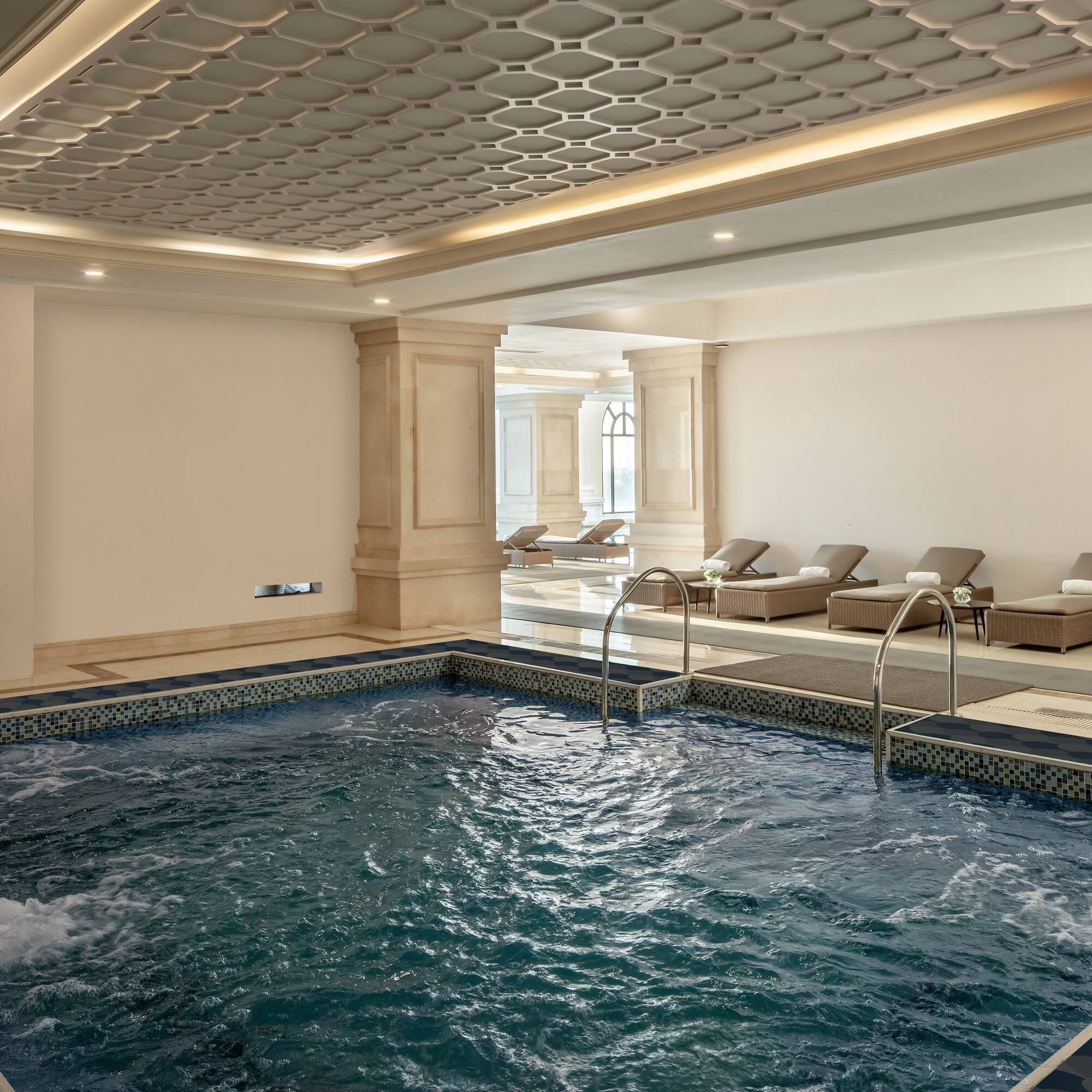 a indoor pool with a large tub