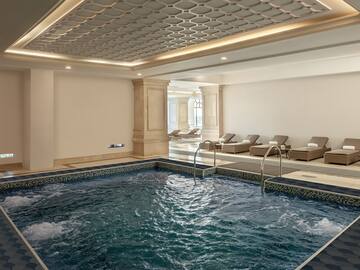 a indoor pool with a large tub