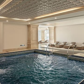 a indoor pool with a large tub
