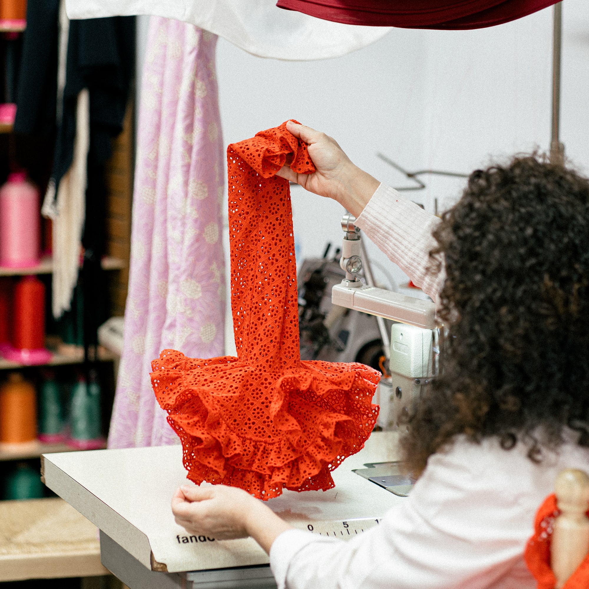 a woman sewing a dress