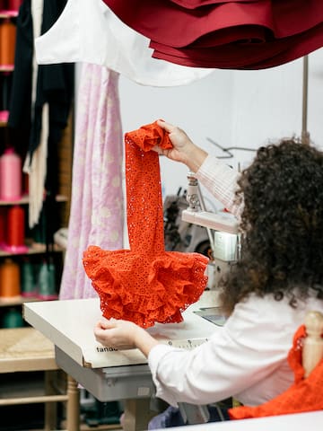 a woman sewing a dress